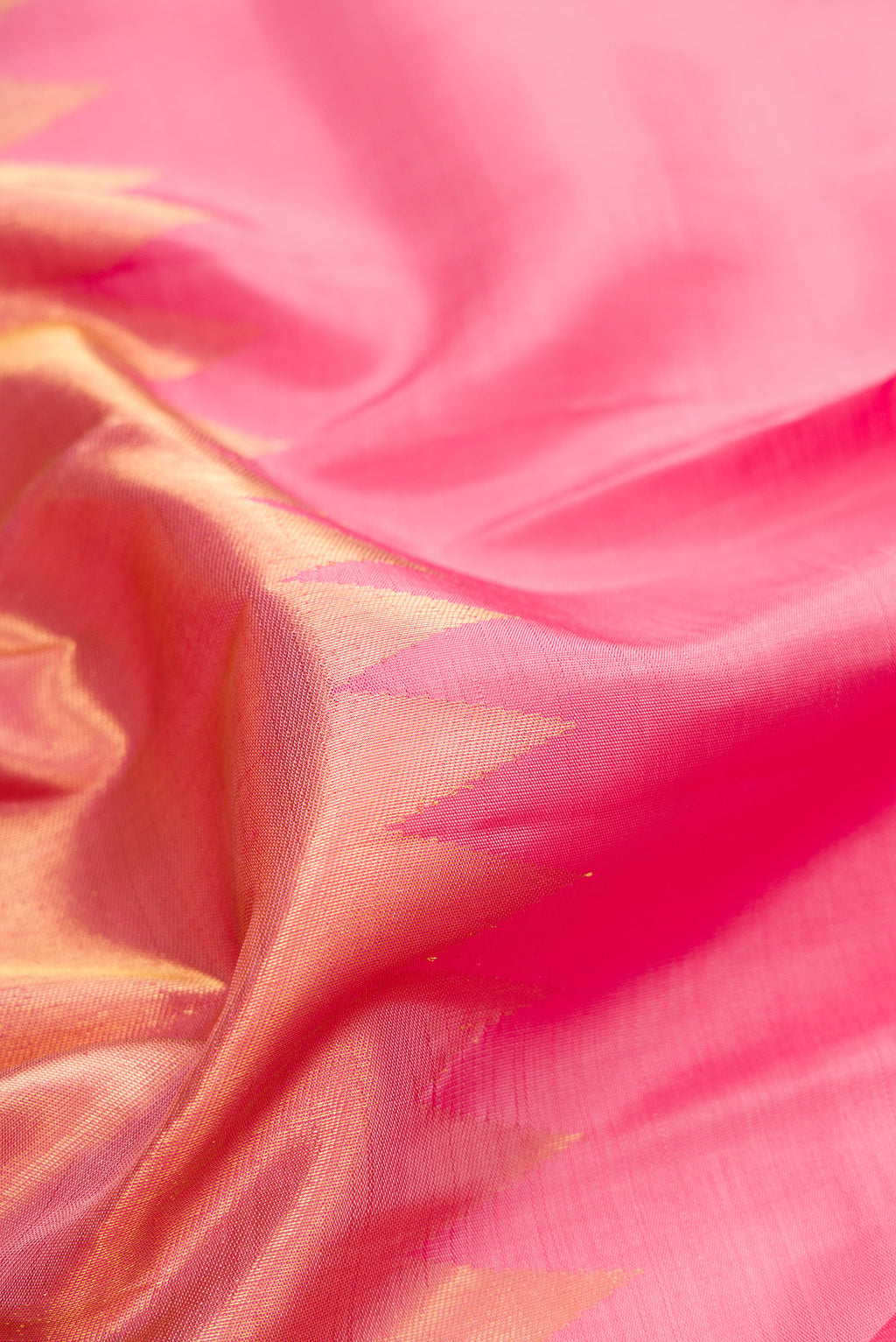 Close up of Pure Silk Pink Dual Tone Kanjivaram Saree with Plain Body and Rising Temple Border.  displaying folds