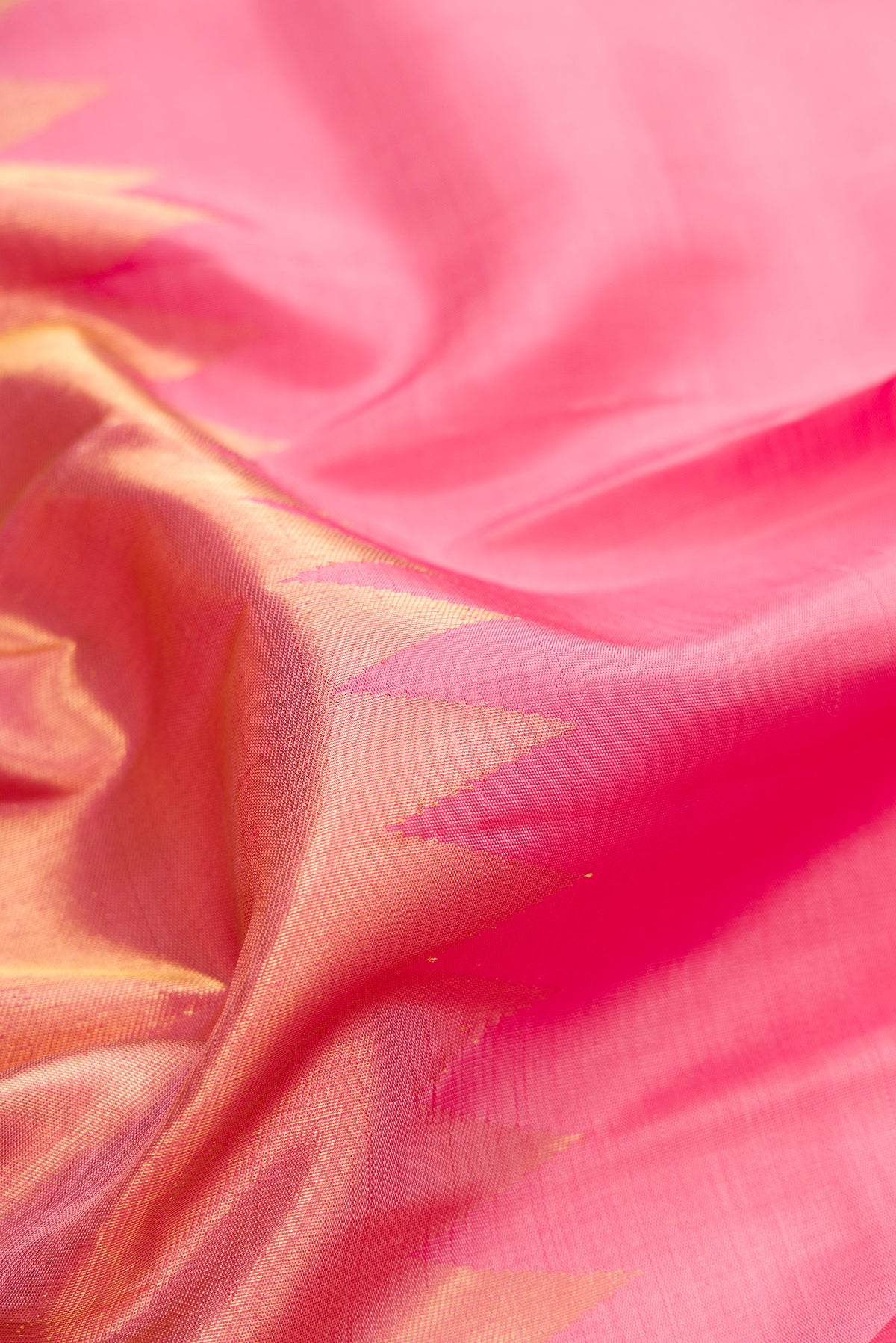 Close up of Pure Silk Pink Dual Tone Kanjivaram Saree with Plain Body and Rising Temple Border.  displaying folds