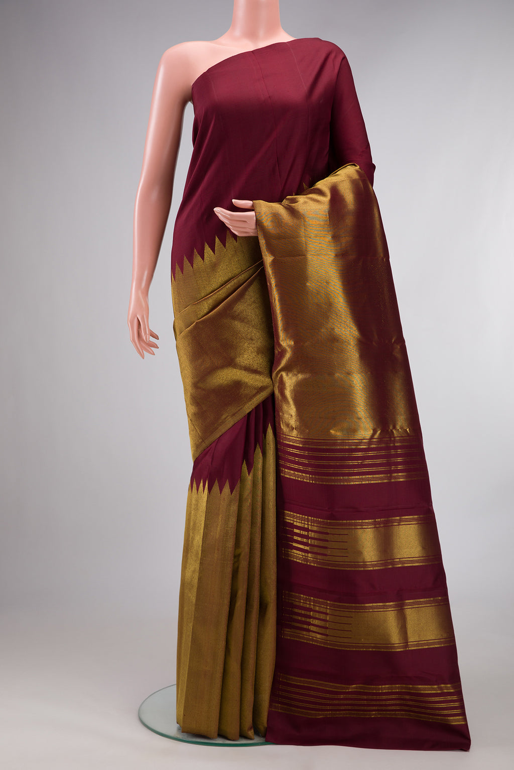 Pure Silk Maroon Kanjivaram Saree with Plain Body and Rising Temple Border.  displayed on a mannequin
