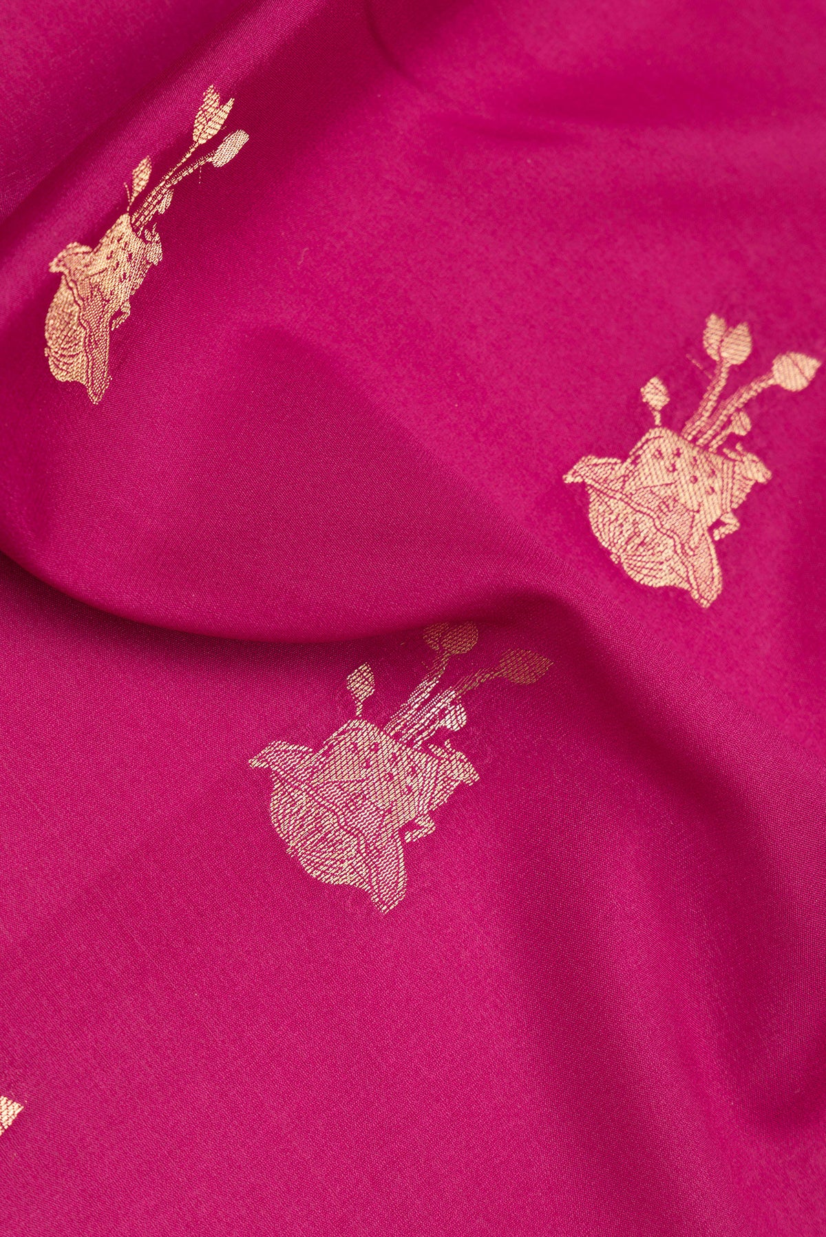 Close up of Magenta Dual Tone Banarasi Georgette Saree with Zari Butta on the body and Zari Border.  displaying folds