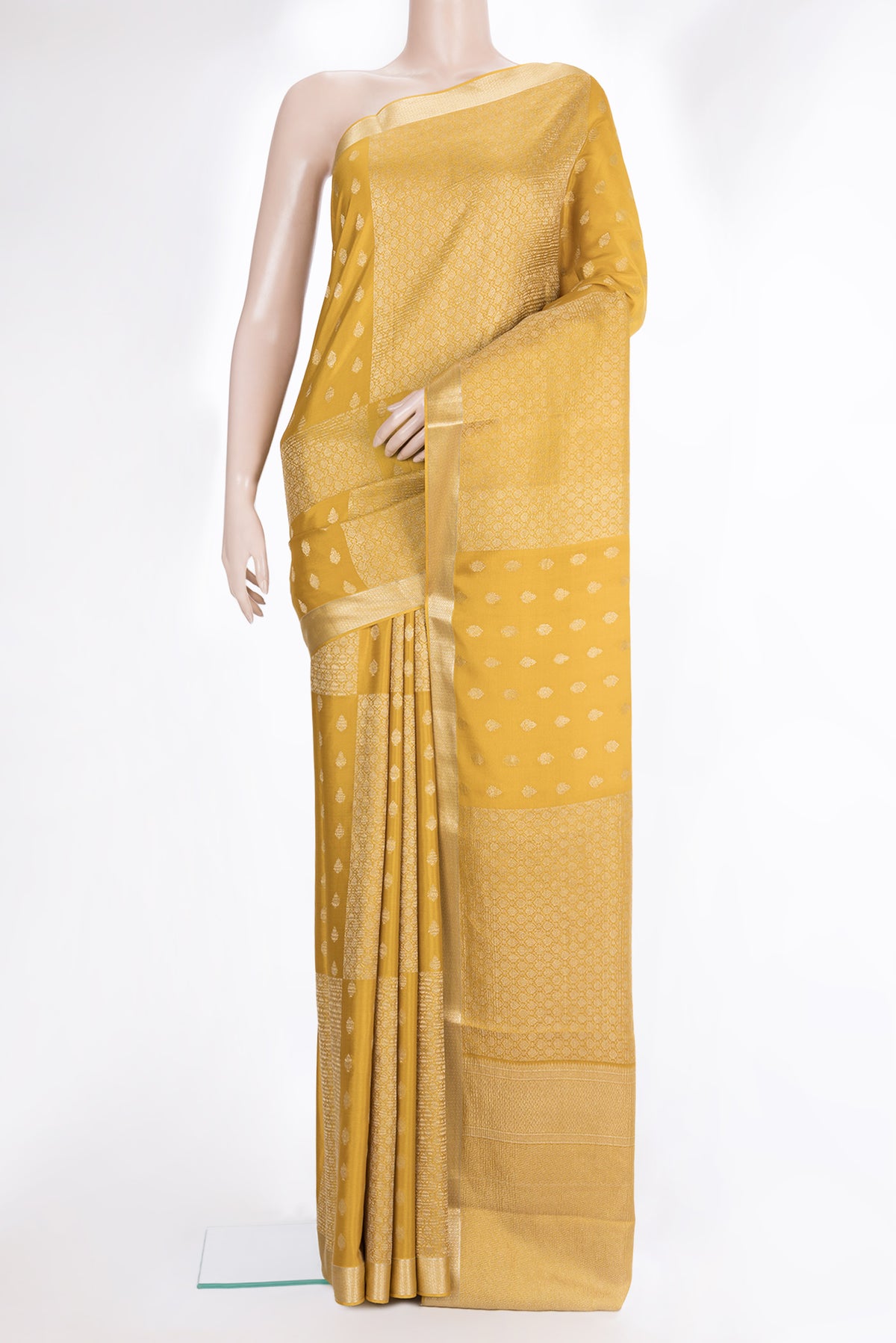 Pure Silk Mustard Dual Tone Banarasi Georgette Saree with Zari Butta on the body and Zari Border.  displayed on a mannequin