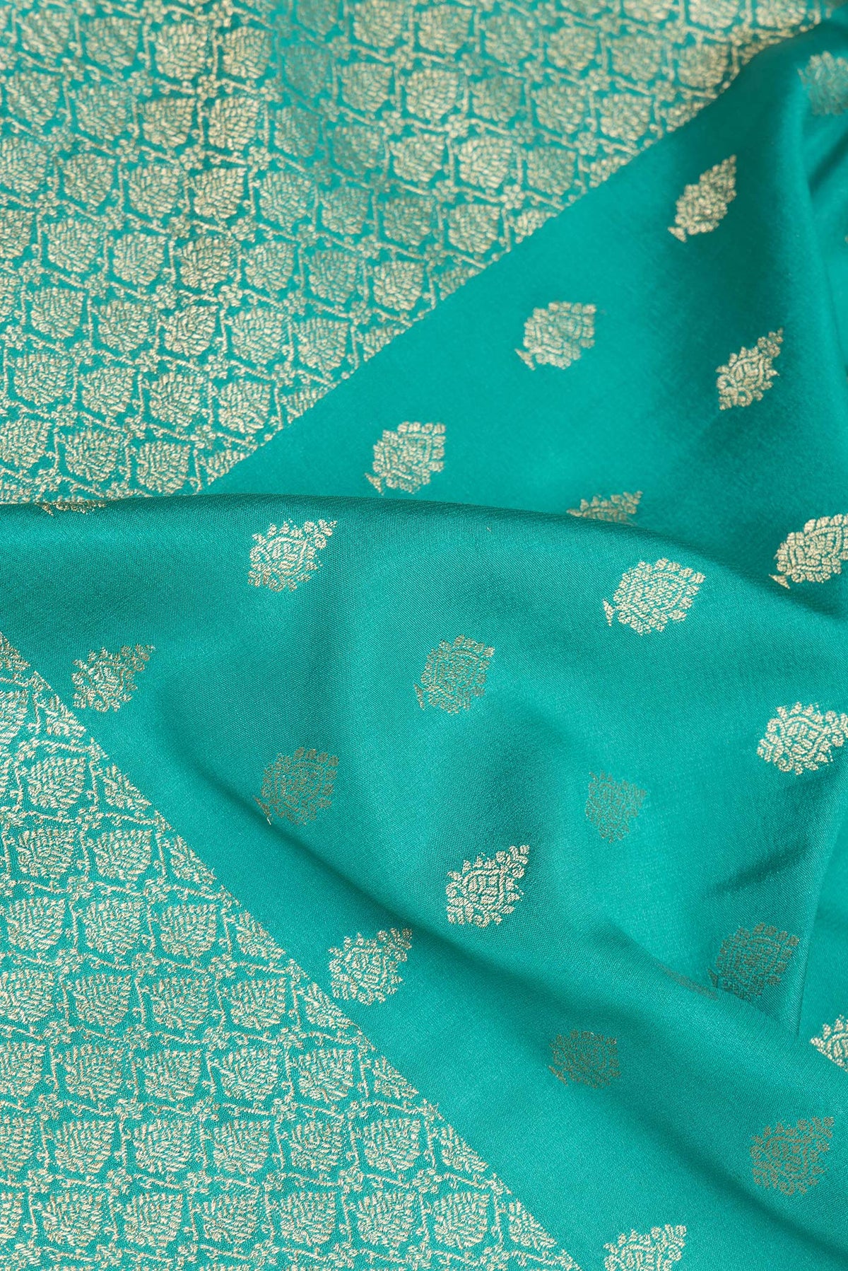 Close up of Pure Silk Sea Green Dual Tone Banarasi Georgette Saree with Zari Butta on the body and Zari Border.  displaying folds
