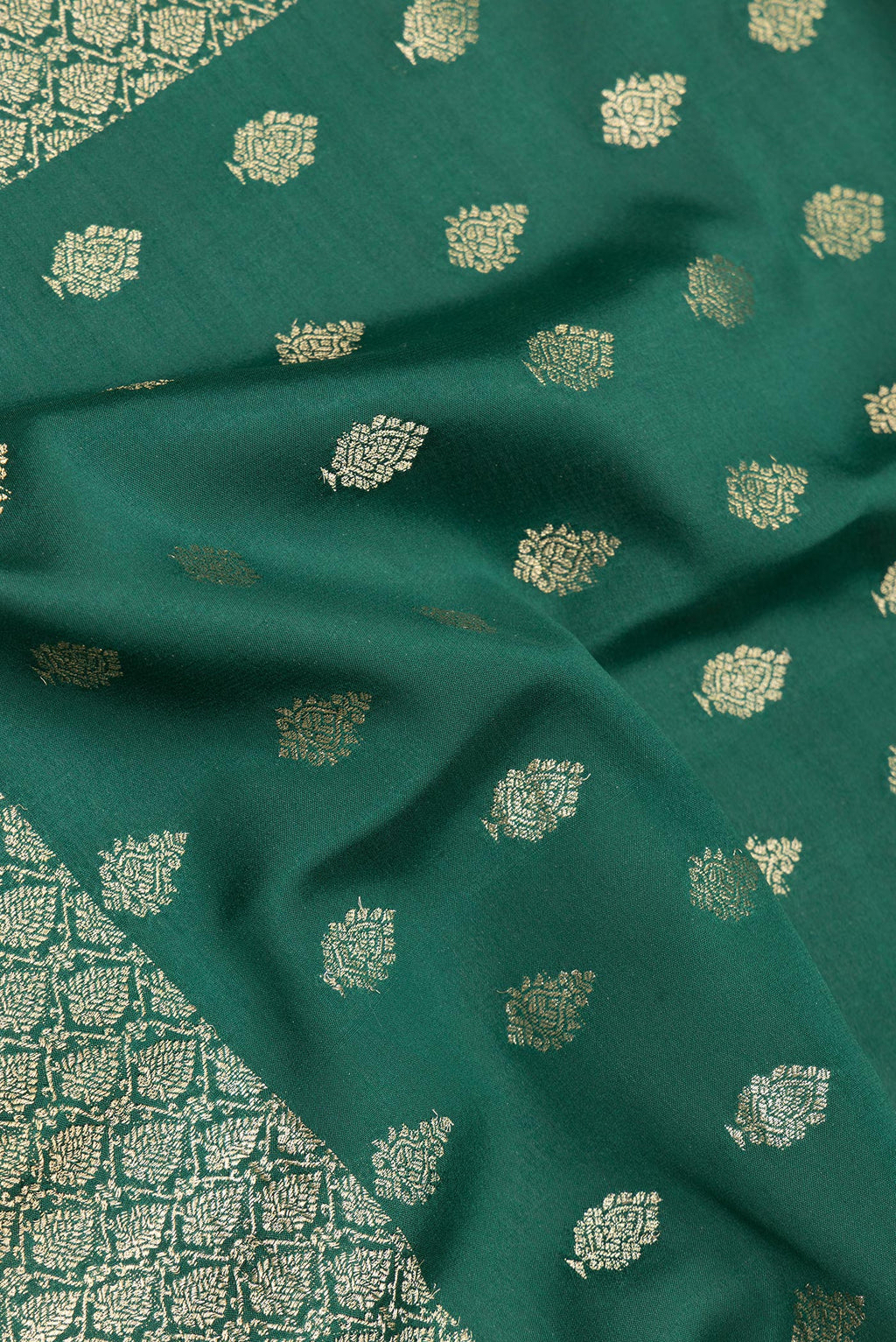 Close up of Bottle Green Dual Tone Banarasi Georgette Saree with Zari Butta on the body and Zari Border.  displaying folds