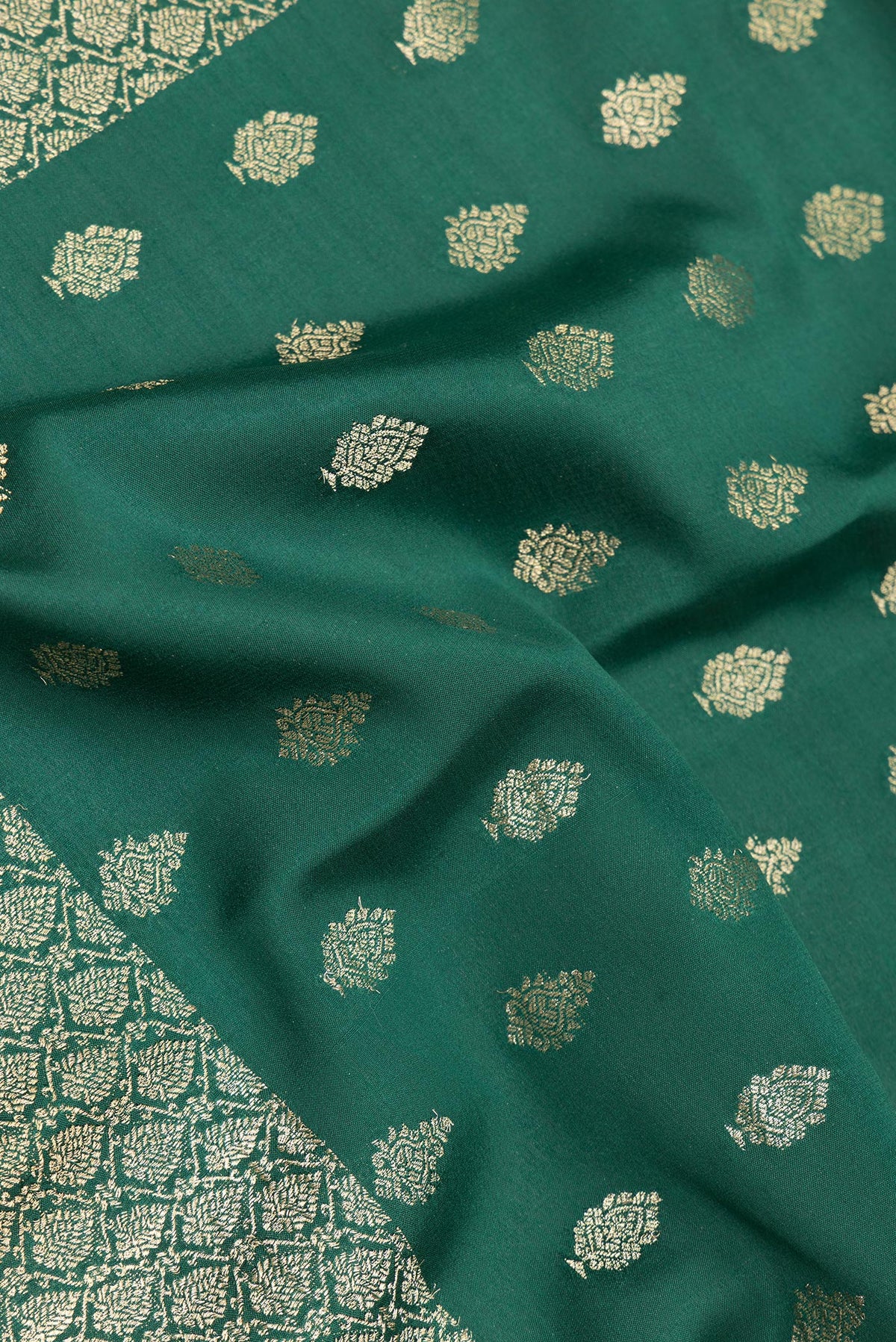 Close up of Bottle Green Dual Tone Banarasi Georgette Saree with Zari Butta on the body and Zari Border.  displaying folds