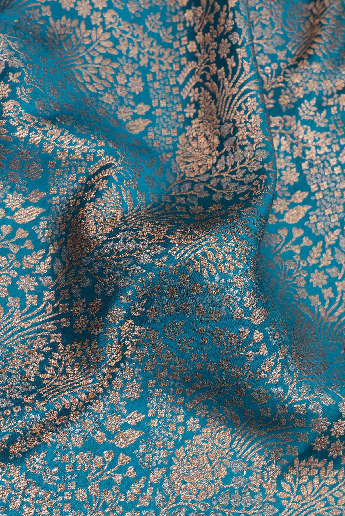 Close up of Peacock Blue Dual Tone Banarasi Georgette Saree with Zari Brocade on the body and Zari Border.  displaying folds