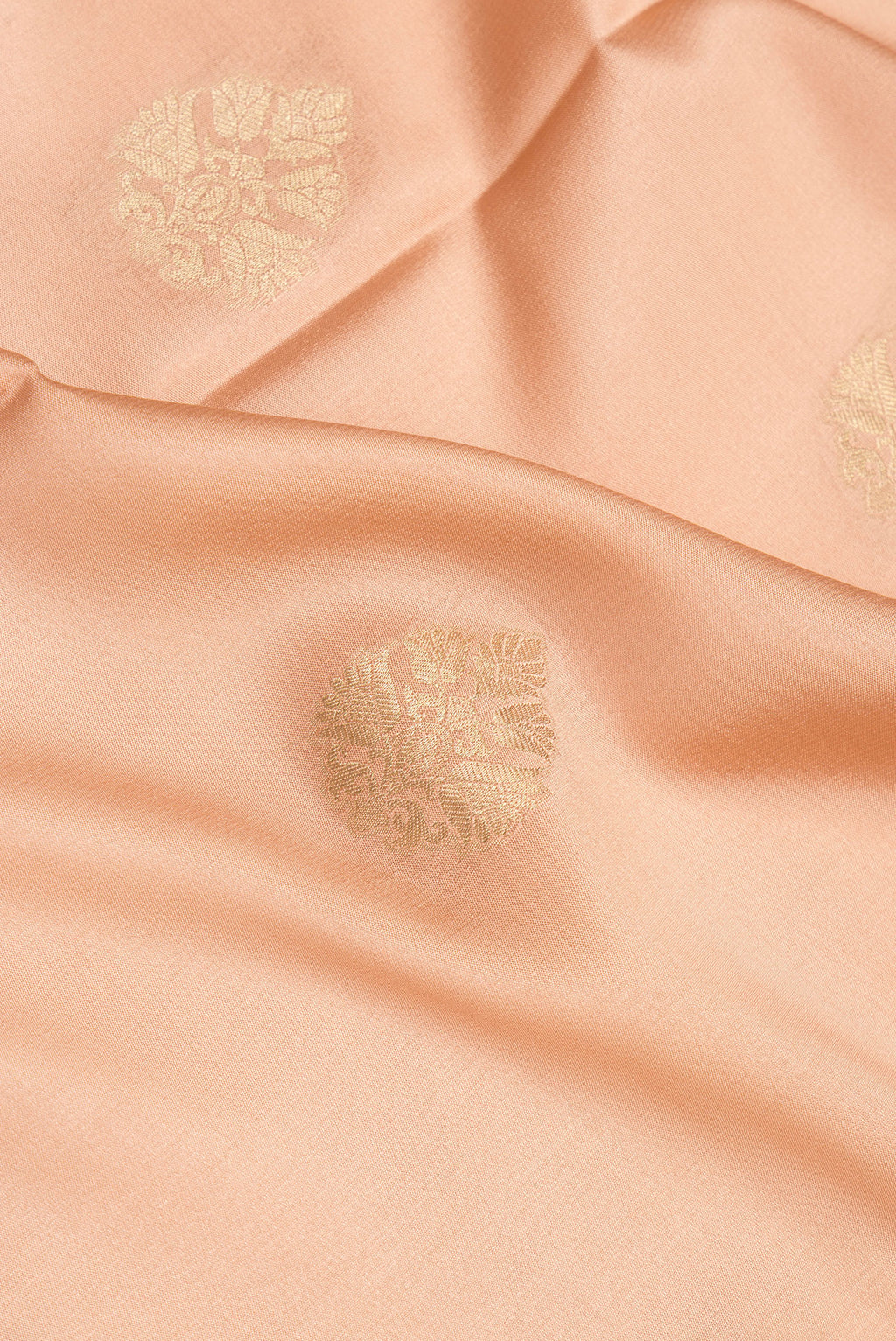 Close up of Pure Silk Golden Peach Dual Tone Banarasi Georgette Saree with Zari Butta on the body and Zari Border.  displaying folds