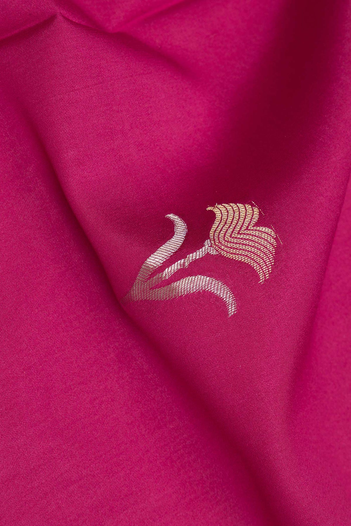 Close up of Magenta Dual Tone Banarasi Georgette Saree with Zari Butta on the body and Zari Border.  displaying folds