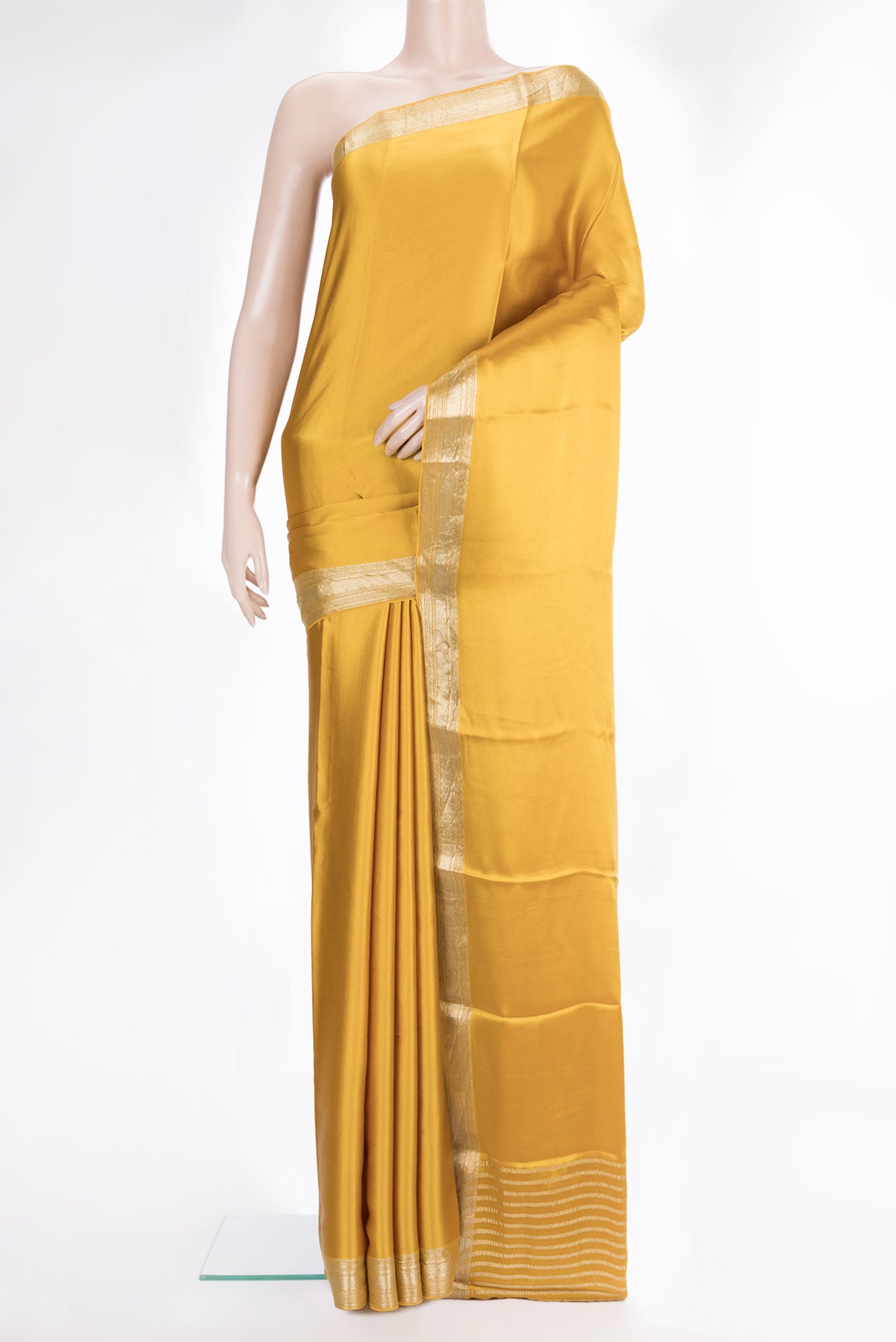 Mustard Satin Crepe Saree with Plain Body and Zari Border.  displayed on a mannequin