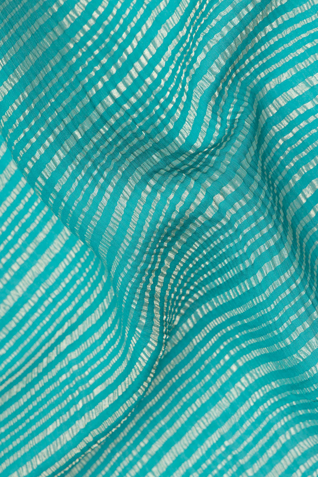 Close up of Sea Green Mysore Georgette Saree with Stripes on the body and Zari Border.  displaying folds