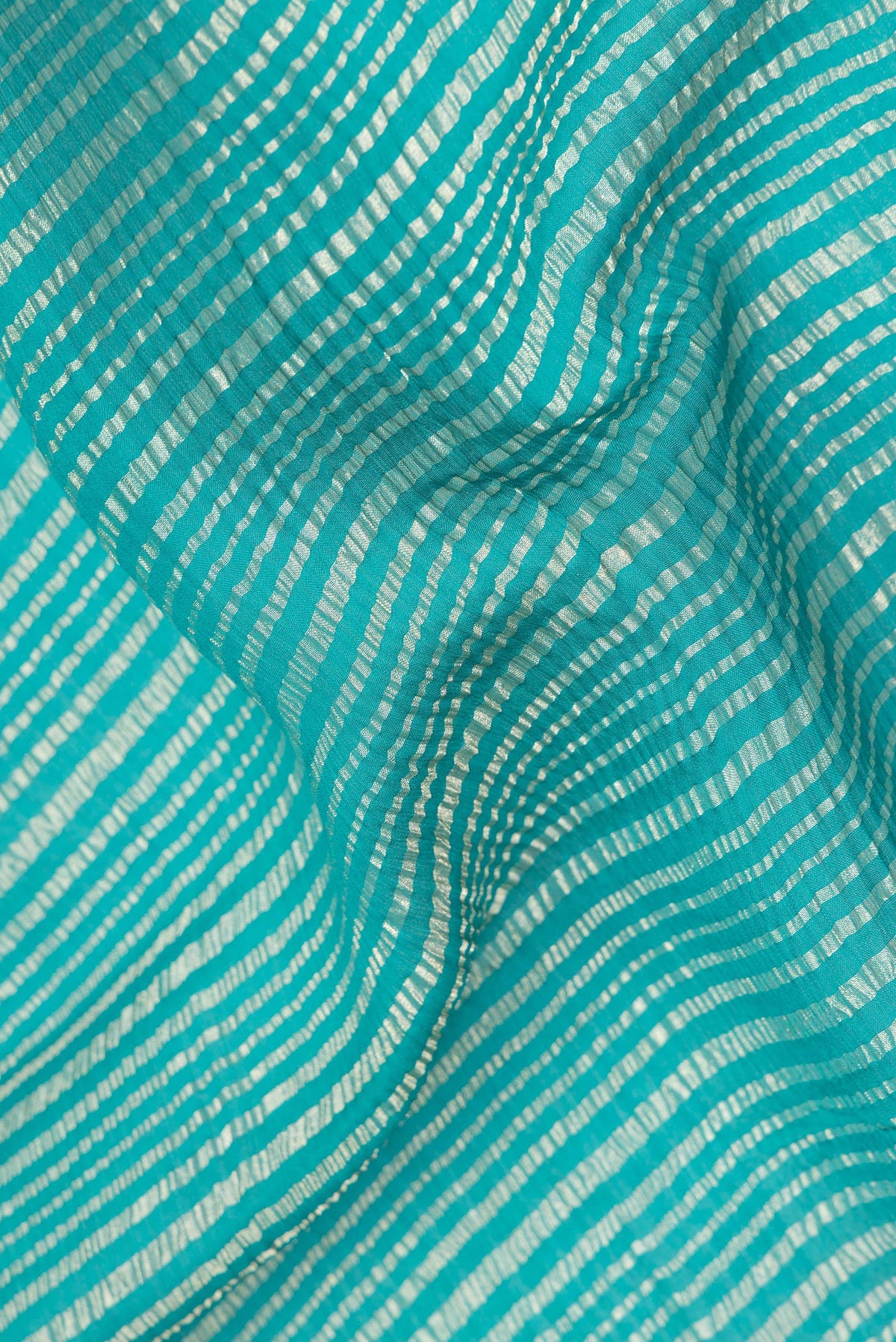 Close up of Sea Green Mysore Georgette Saree with Stripes on the body and Zari Border.  displaying folds