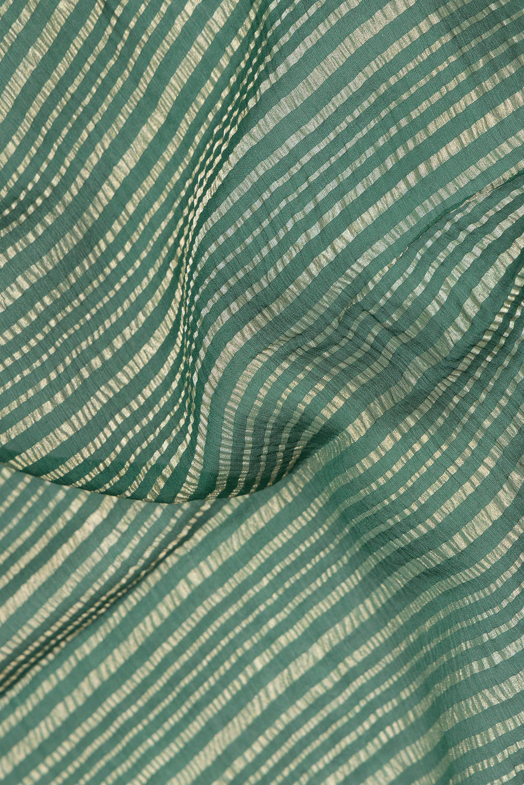 Close up of Bottle Green Mysore Georgette Saree with Stripes on the body and Zari Border.  displaying folds