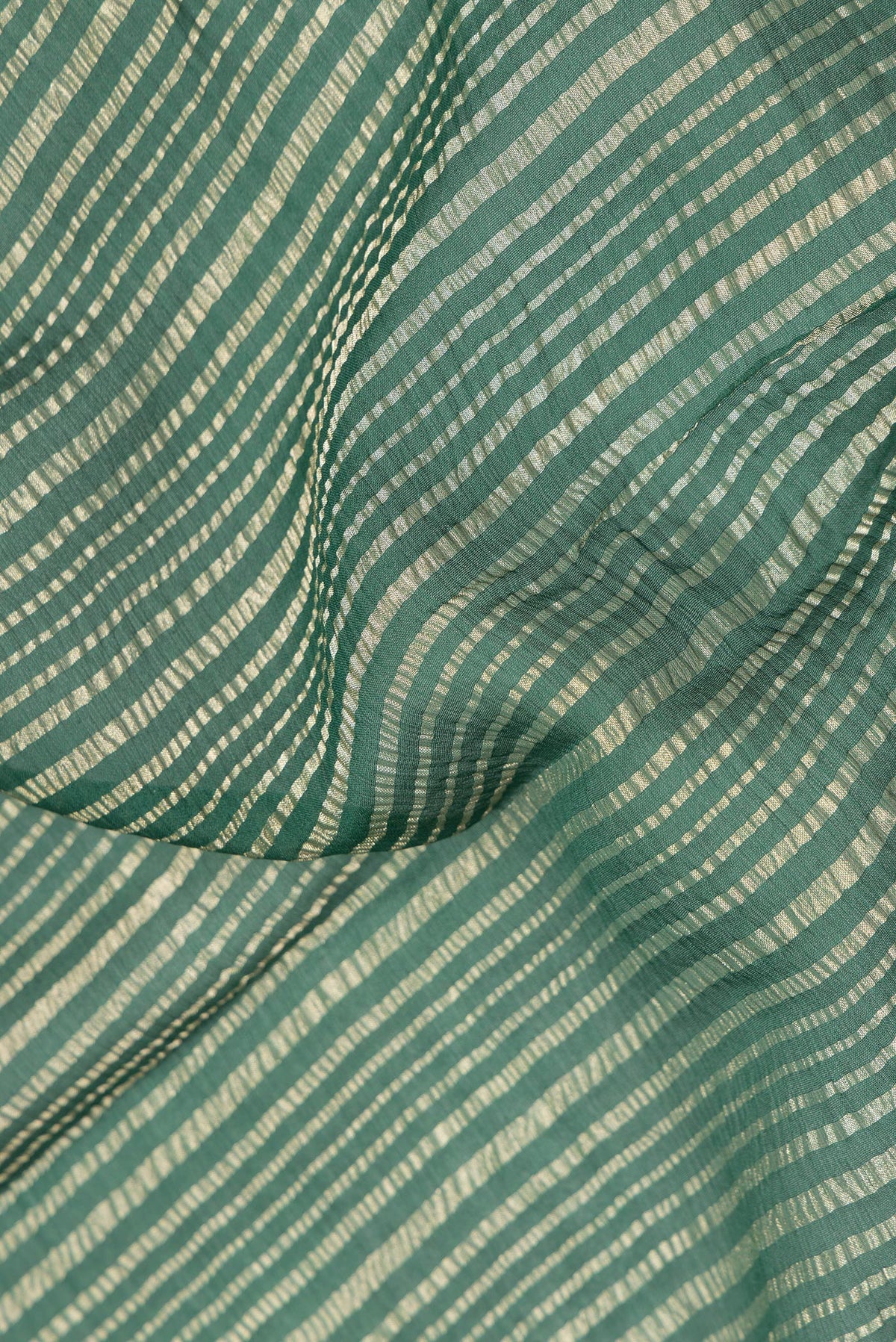 Close up of Bottle Green Mysore Georgette Saree with Stripes on the body and Zari Border.  displaying folds