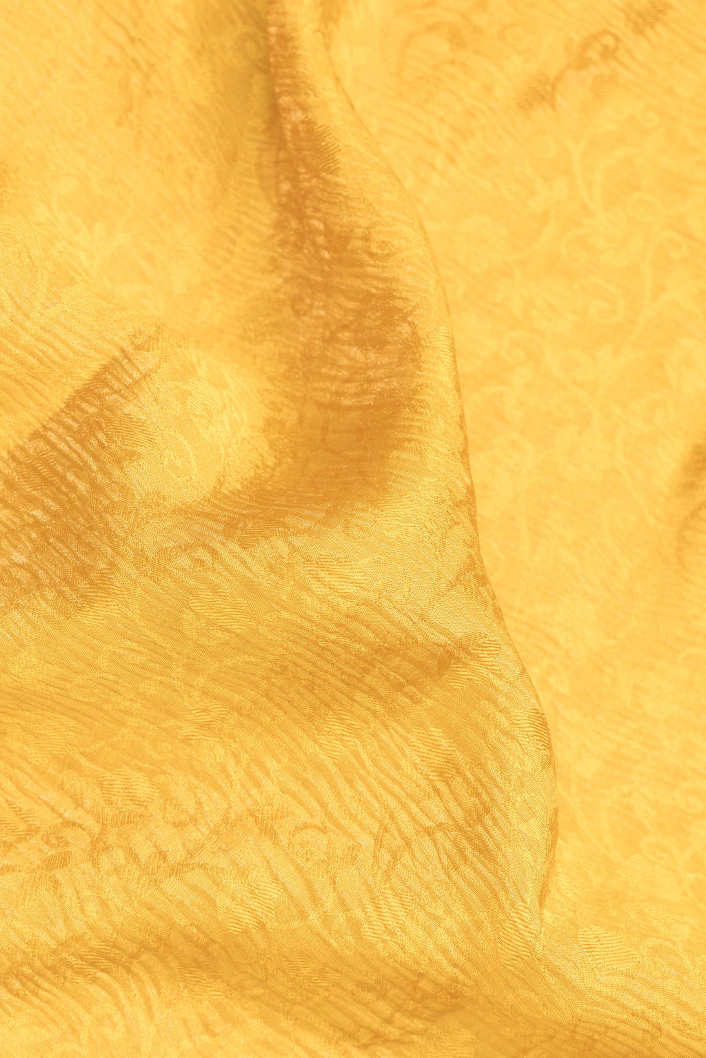Close up of Mustard Dual Tone Banarasi Georgette Saree with Zari Brocade on the body and Zari Border.  displaying folds