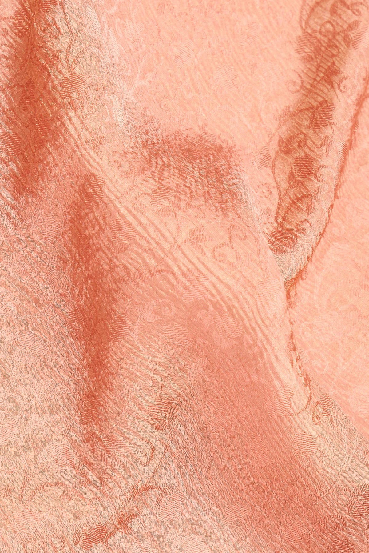 Close up of Golden Peach Dual Tone Banarasi Georgette Saree with Zari Brocade on the body and Zari Border.  displaying folds