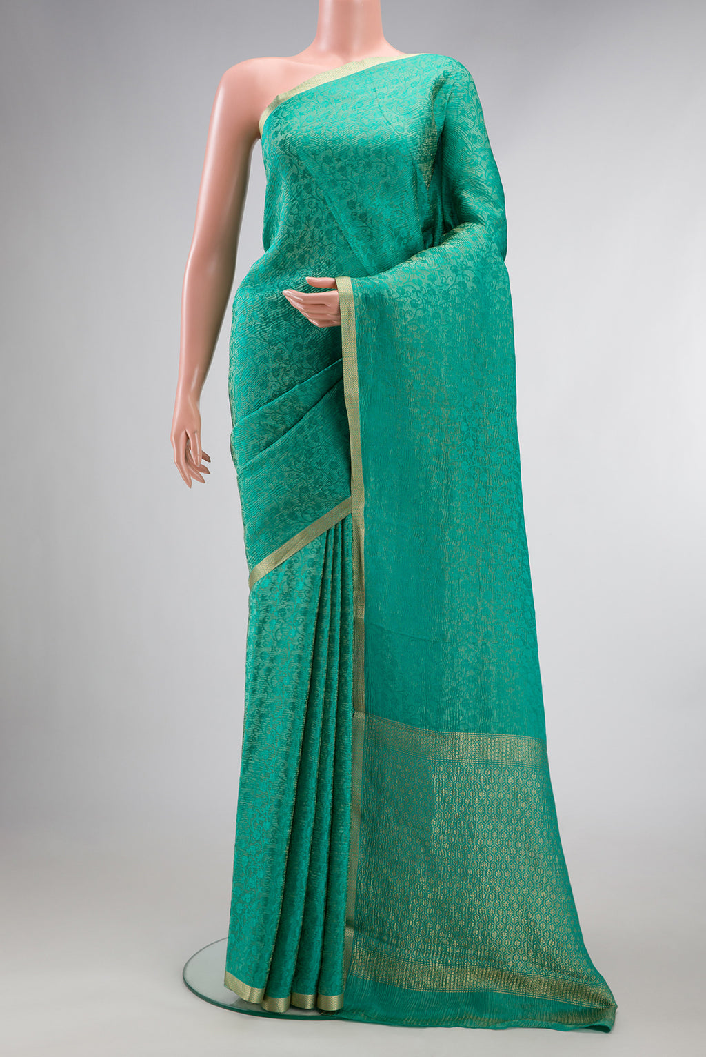 Sea Green Mysore Crepe Saree with Zari Brocade on the body and Zari Border.  displayed on a mannequin