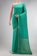 Sea Green Mysore Crepe Saree with Zari Brocade on the body and Zari Border.  displayed on a mannequin