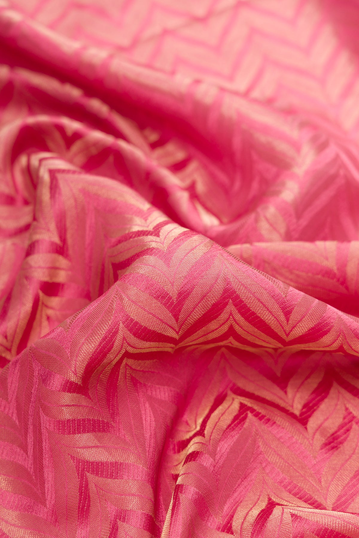 Close up of Pink Mysore Crepe Saree with Zari Brocade on the body and Zari Border.  displaying folds