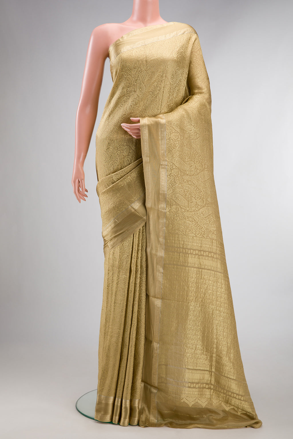 Beige Mysore Crepe Saree with Zari Brocade on the body and Zari Border.  displayed on a mannequin