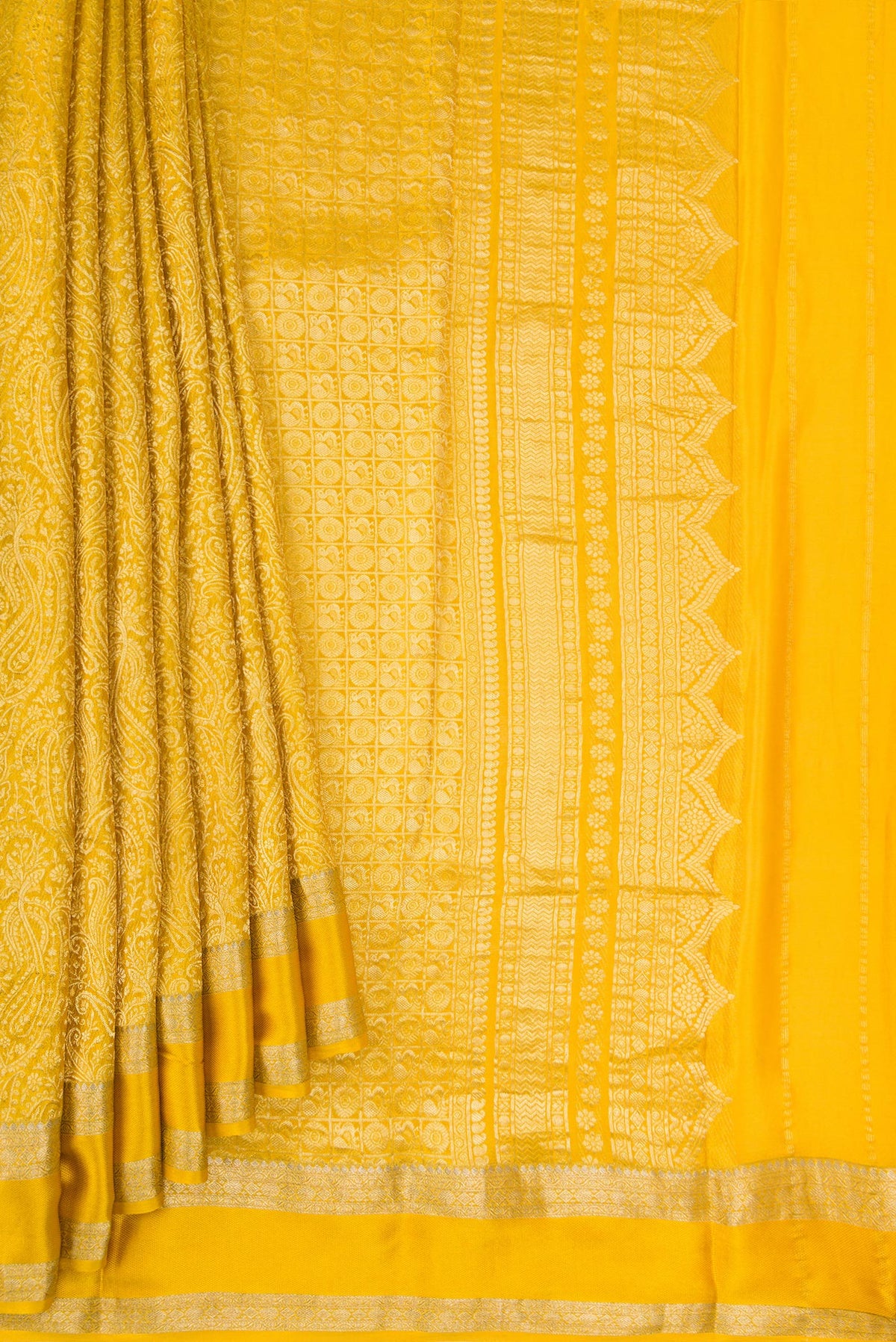 Pleats and pallu of Mustard Mysore Crepe Saree with Zari Brocade on the body and Zari Border. 