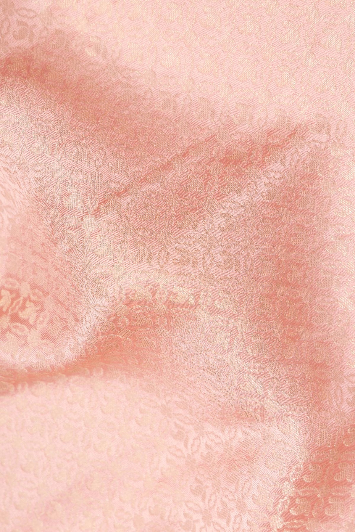 Close up of Peach Dual Tone Banarasi Georgette Saree with Zari Brocade on the body and Zari Border.  displaying folds