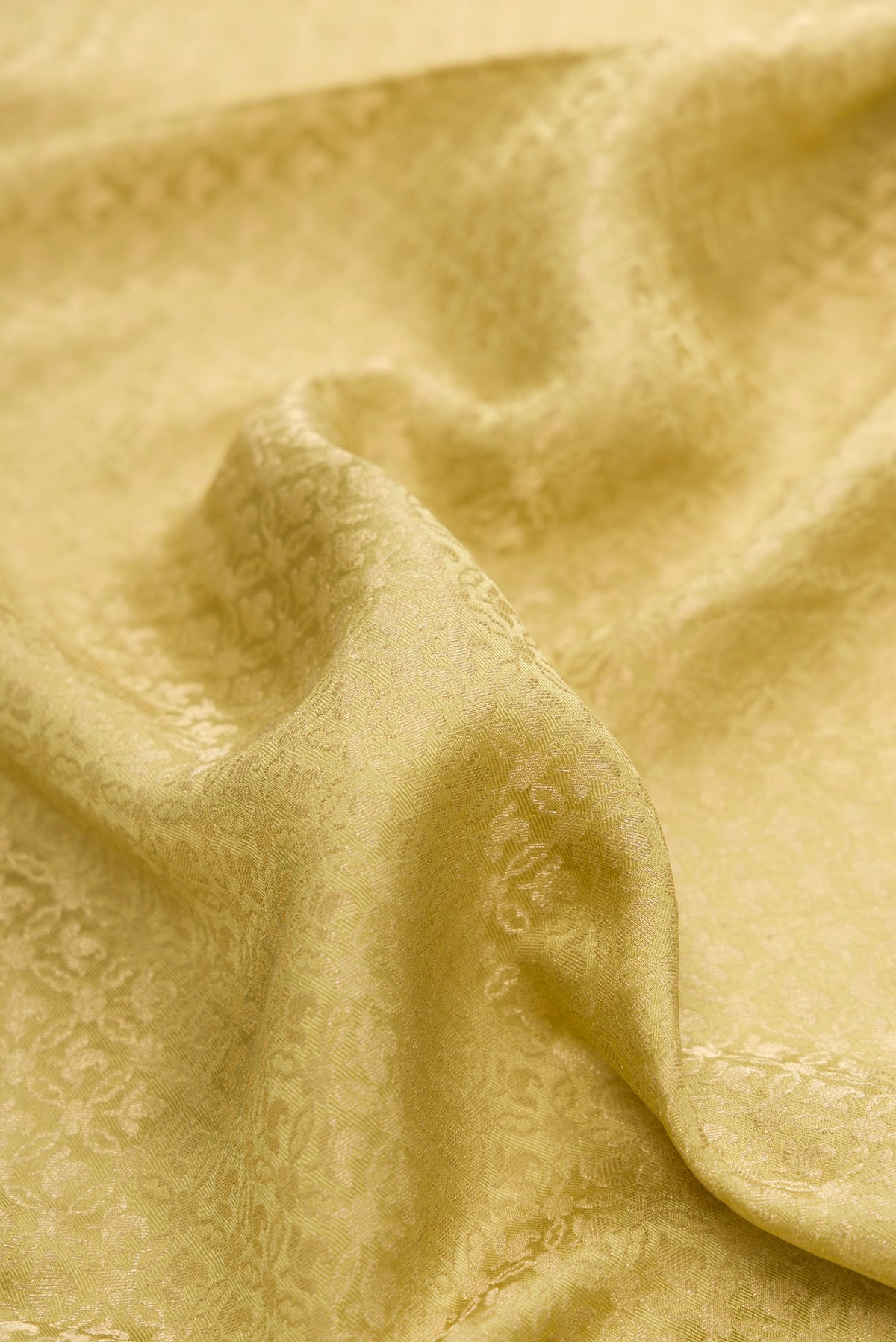 Close up of Pista Green Mysore Crepe Saree with Zari Brocade on the body and Zari Border.  displaying folds