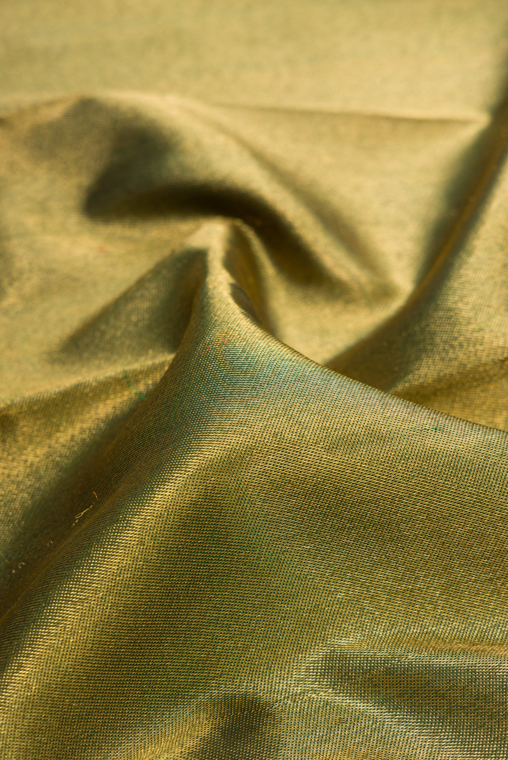Close up of Pure Silk Pure Zari Green Dual Tone Kanjivaram Saree with Zari Brocade on the body and Zari Border.  displaying folds