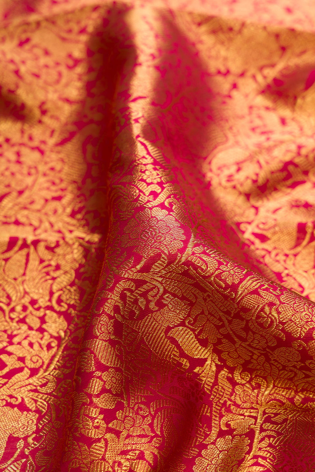 Close up of Pure Silk Pure Zari Red Kanjivaram Saree with Zari Brocade on the body and Zari Border.  displaying folds