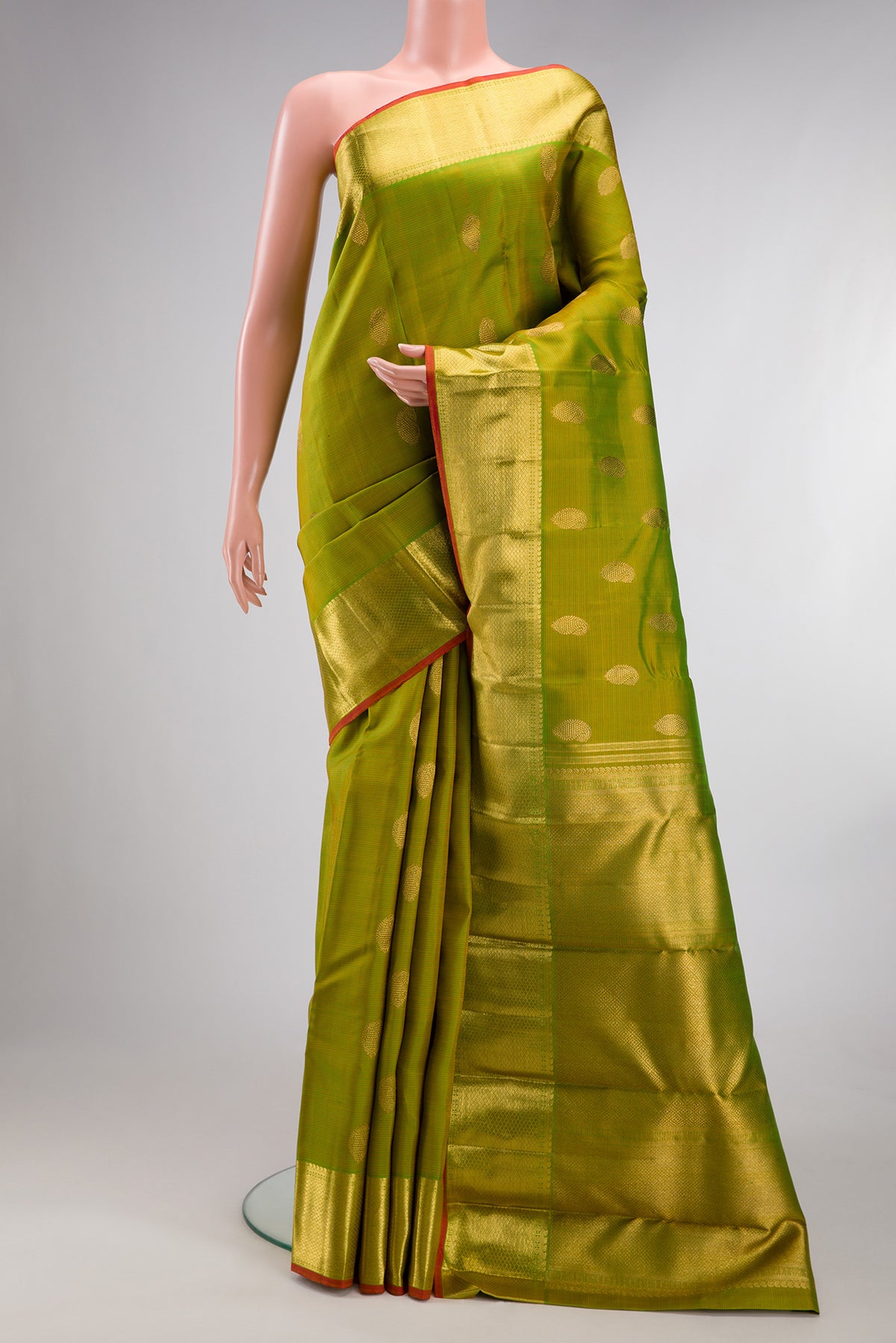 Pure Silk Pure Zari Parrot Green Dual Tone Kanjivaram Saree with Stripes on the body and Zari Border.  displayed on a mannequin