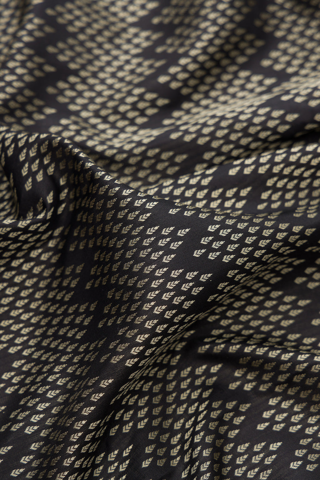Close up of Pure Silk Coffee Brown Kanjivaram Saree with Jacquard design on the body and Ganga Jamuna Border.  displaying folds