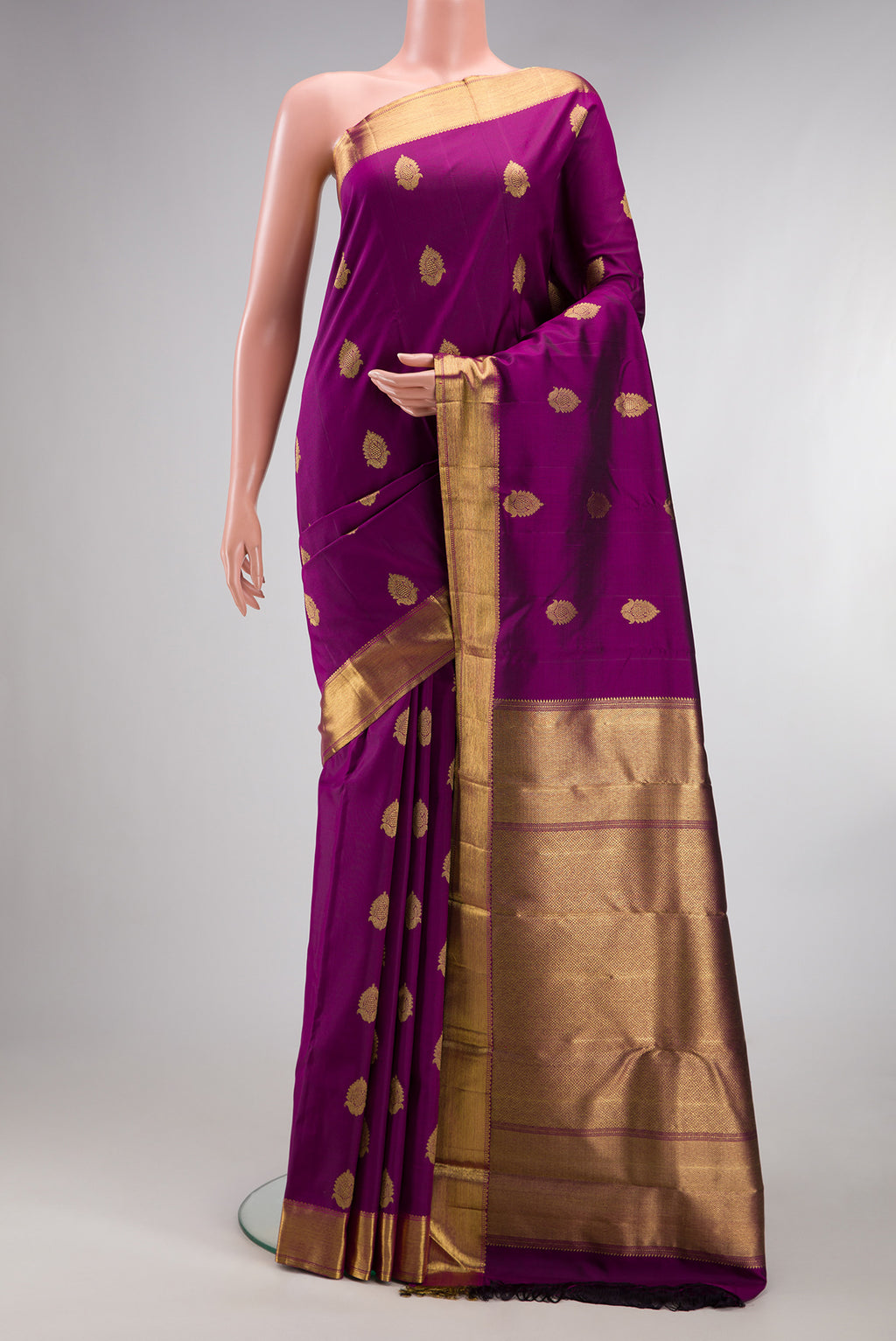Pure Silk Pure Zari Purple Kanjivaram Saree with Zari Butta on the body and Zari Border.  displayed on a mannequin