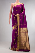 Pure Silk Pure Zari Purple Kanjivaram Saree with Zari Butta on the body and Zari Border.  displayed on a mannequin