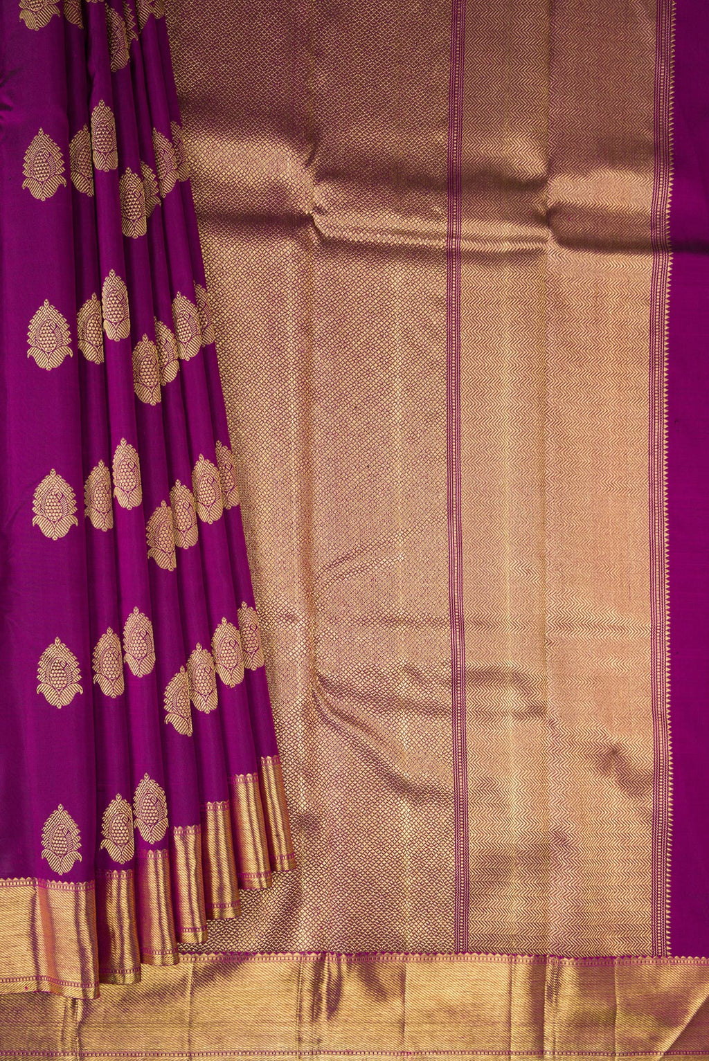 Pleats and pallu of Pure Silk Pure Zari Purple Kanjivaram Saree with Zari Butta on the body and Zari Border. 