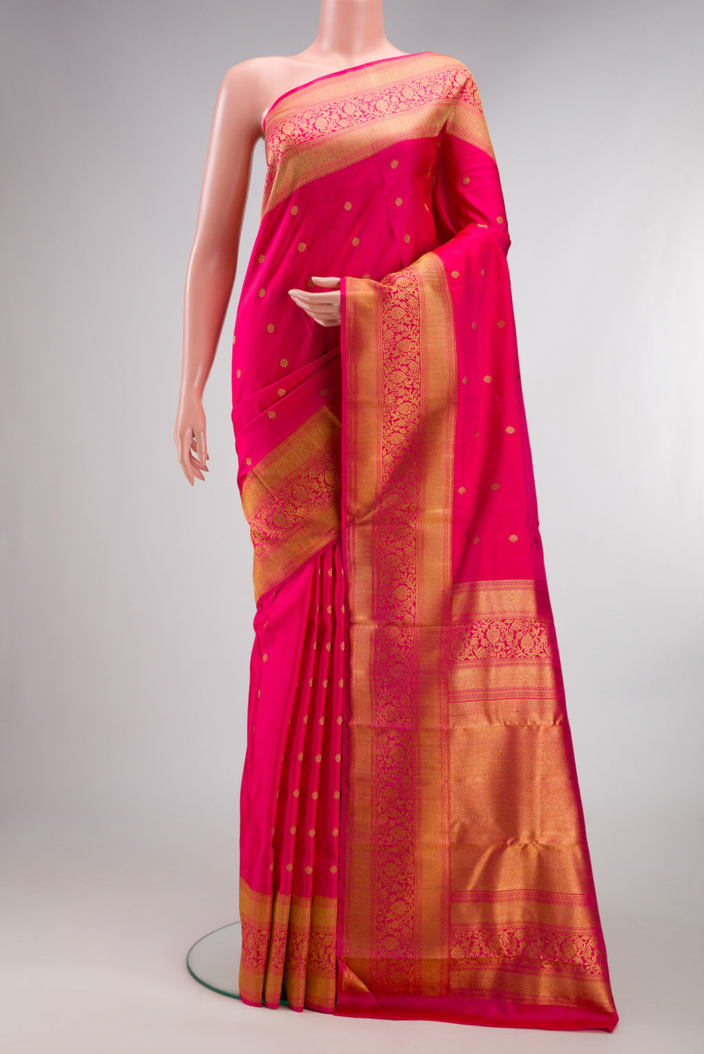 Pure Silk Pure Zari Dark Pink Kanjivaram Saree with Zari Butta on the body and Fancy Border.  displayed on a mannequin