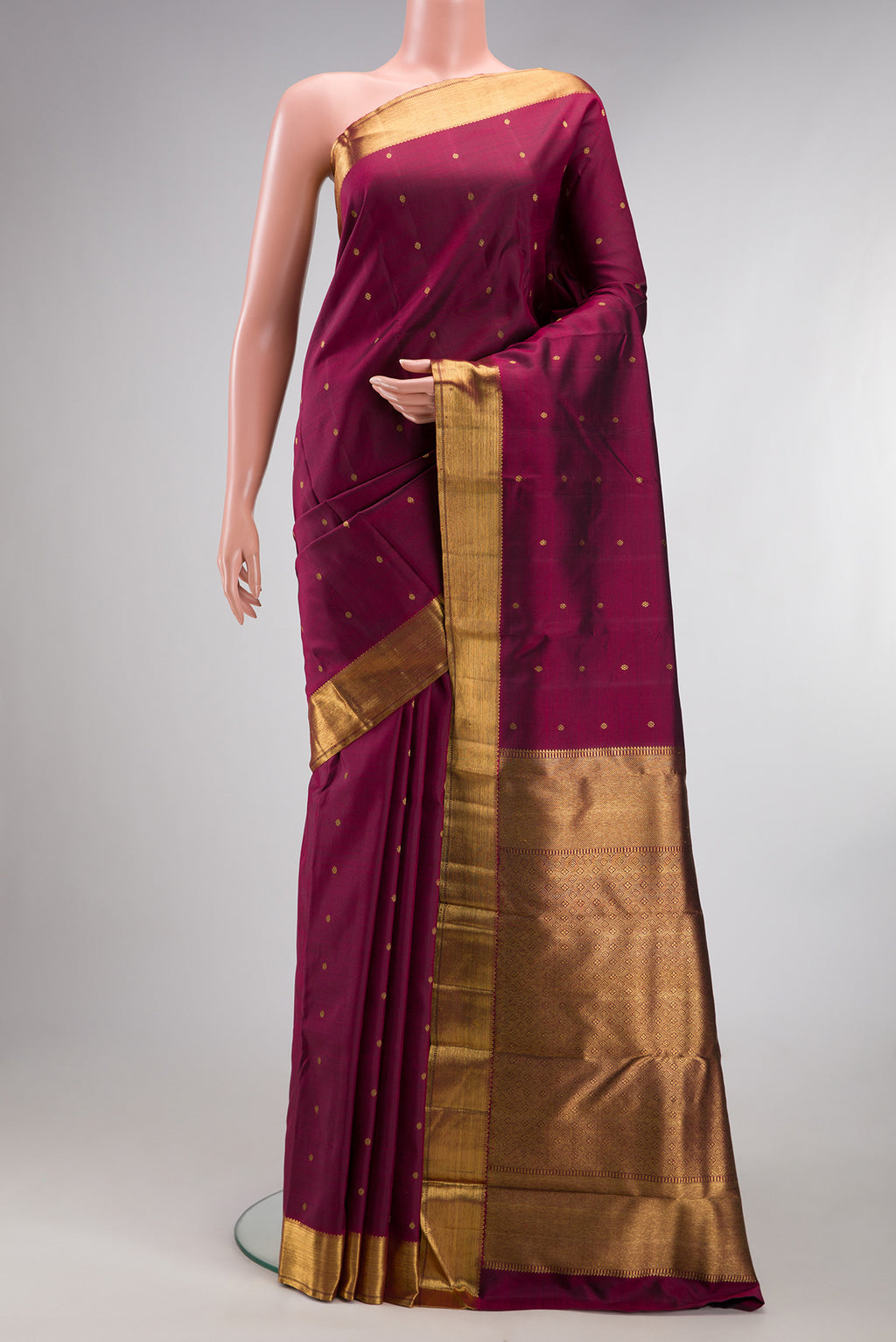Pure Silk Pure Zari Maroon Kanjivaram Saree with Zari Butta on the body and Zari Border.  displayed on a mannequin