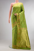 Pure Silk Pure Zari Parrot Green Kanjivaram Saree with Zari And Thread Butta on the body and Fancy Border.  displayed on a mannequin