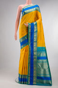 Pure Silk Pure Zari Yellow Kanjivaram Saree with Zari Butta on the body and Zari Border.  displayed on a mannequin