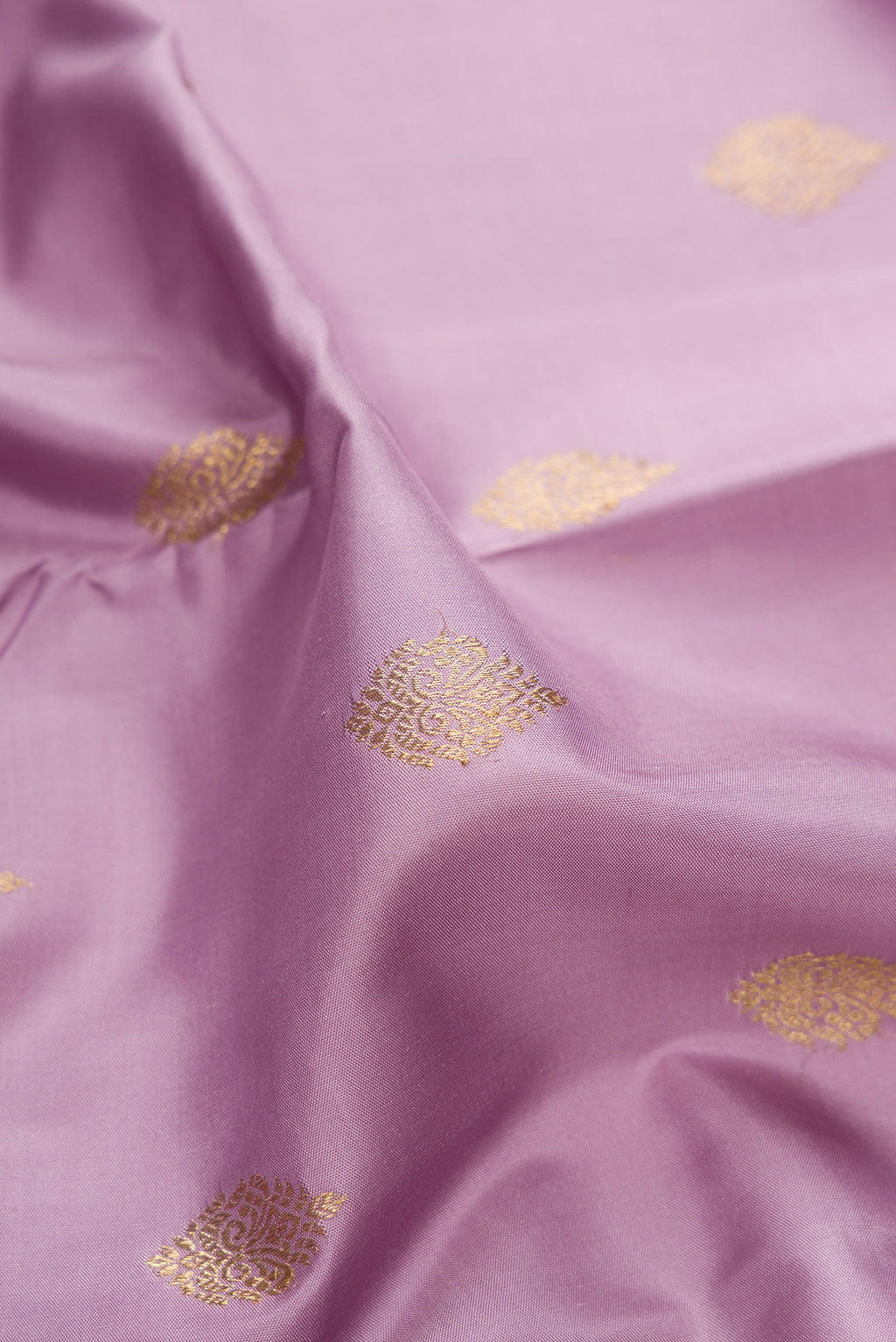 Close up of Pure Silk Pure Zari Lavender Dual Tone Kanjivaram Saree with Zari Butta on the body and Zari Border.  displaying folds