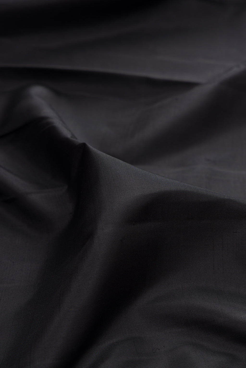 Close up of Pure Silk Pure Zari Black Kanchipuram Saree with Plain Body and Checks Border.  displaying folds
