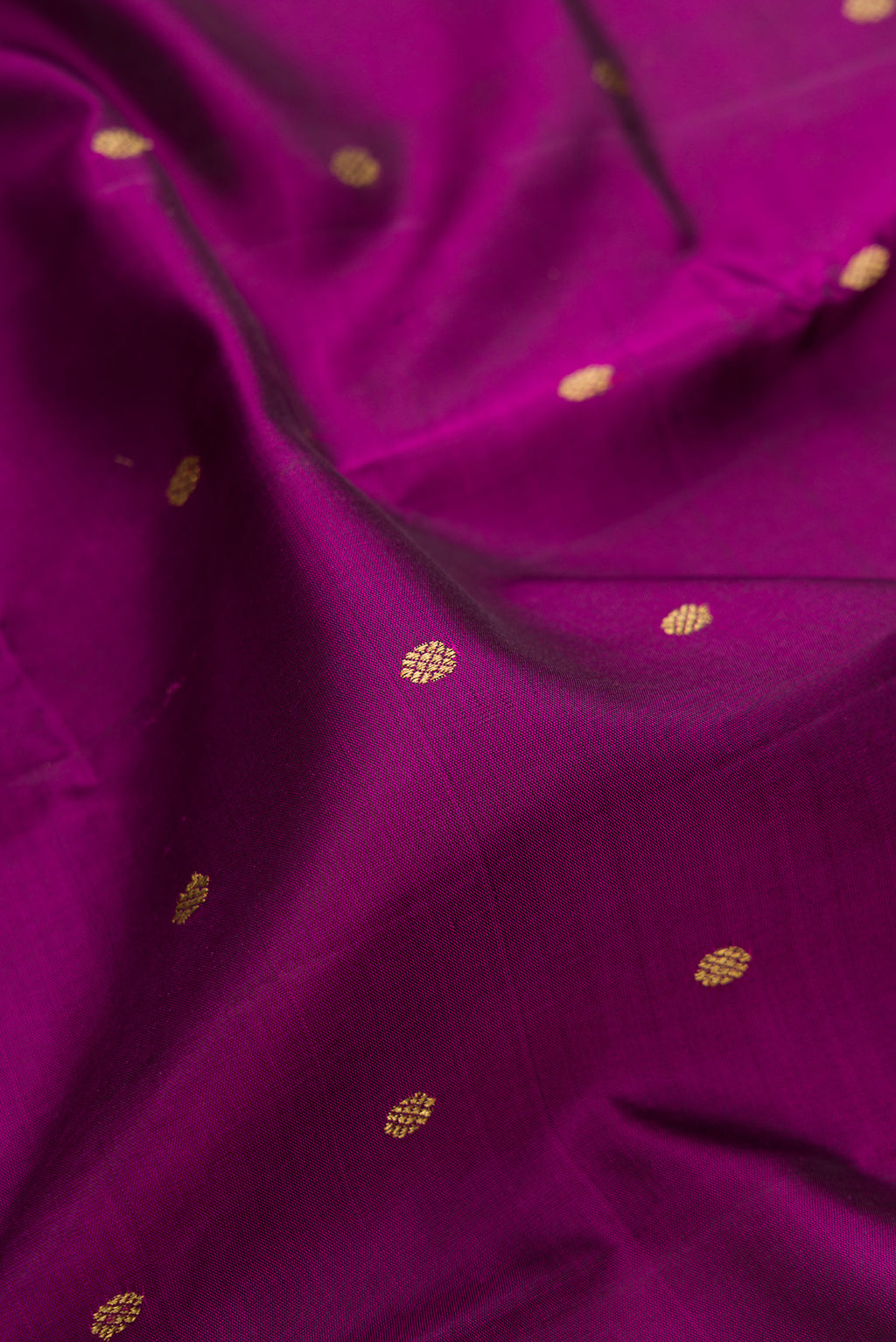 Close up of Pure Silk Pure Zari Purple Dual Tone Kanjivaram Saree with Zari Butta on the body and Zari Border.  displaying folds