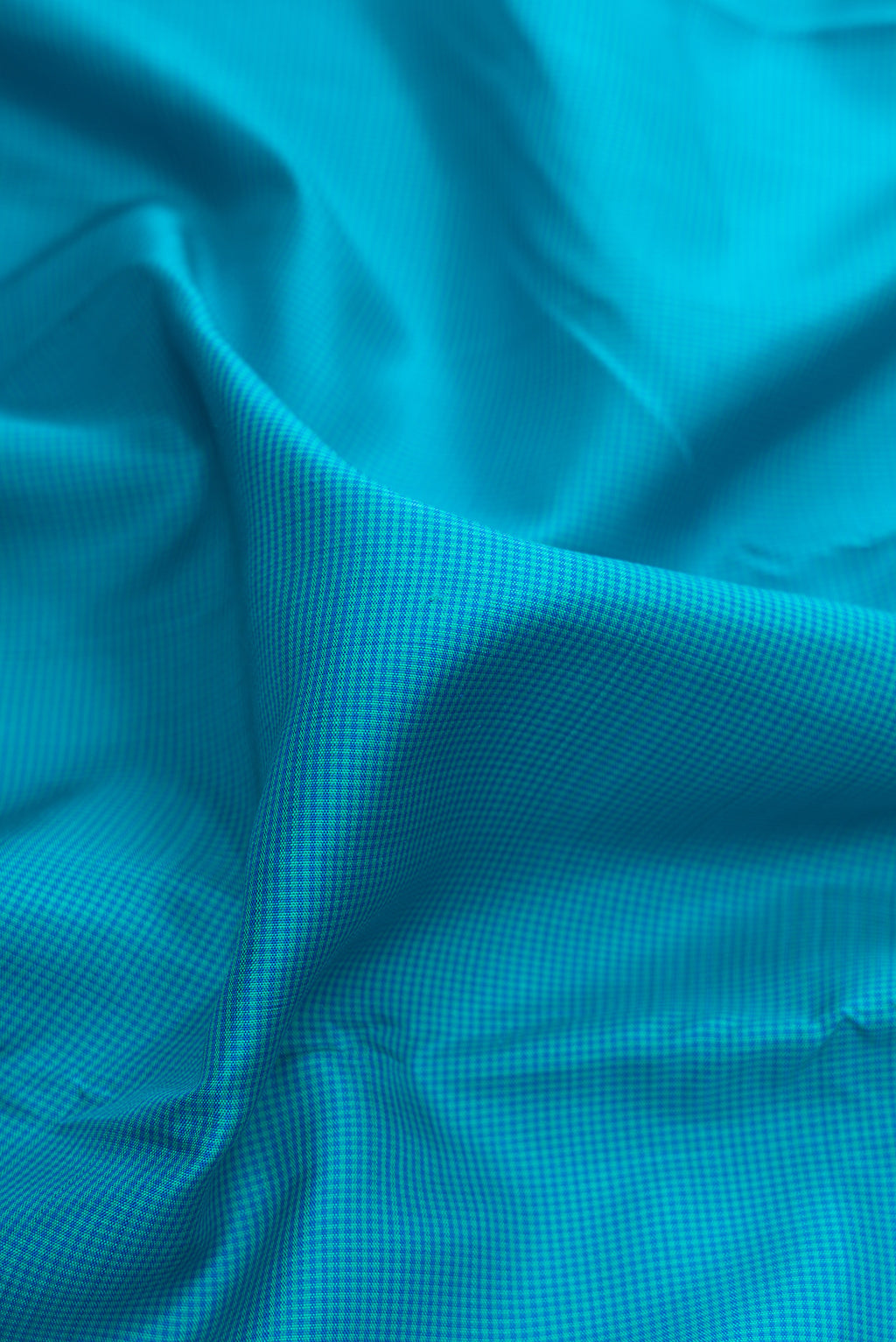 Close up of Pure Silk Sky Blue Kanjivaram Saree with Checked design on the body and Thread Border.  displaying folds