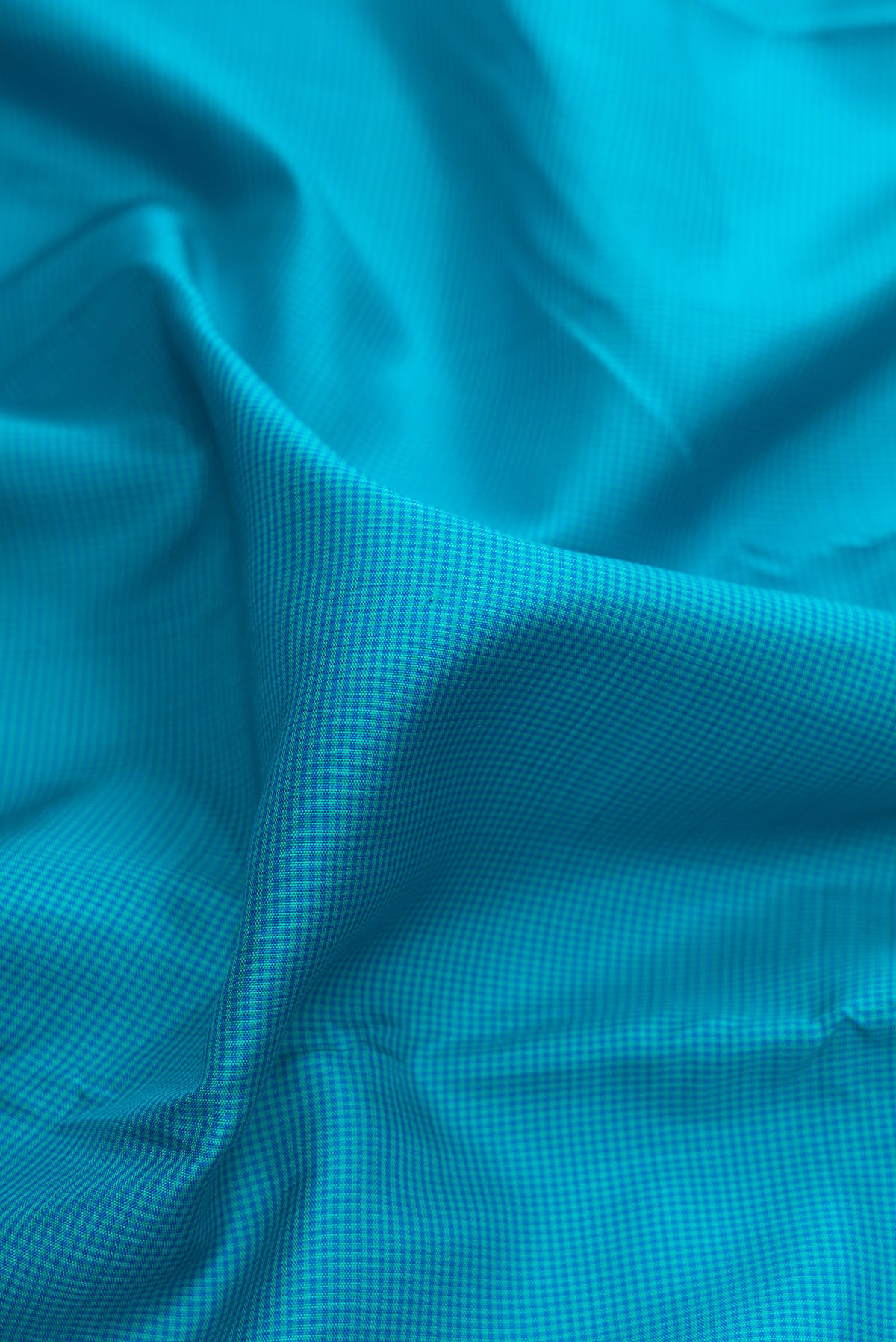 Close up of Pure Silk Sky Blue Kanjivaram Saree with Checked design on the body and Thread Border.  displaying folds