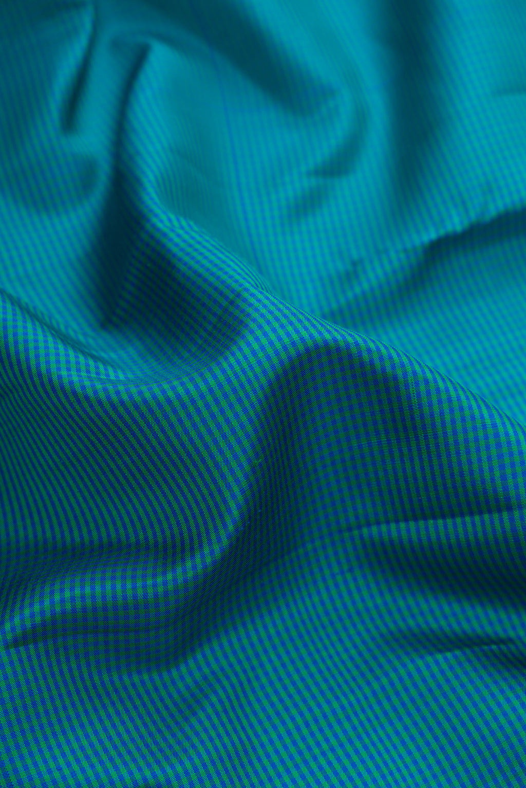 Close up of Pure Silk Peacock Blue Dual Tone Kanjivaram Saree with Checked design on the body and Zari Border.  displaying folds