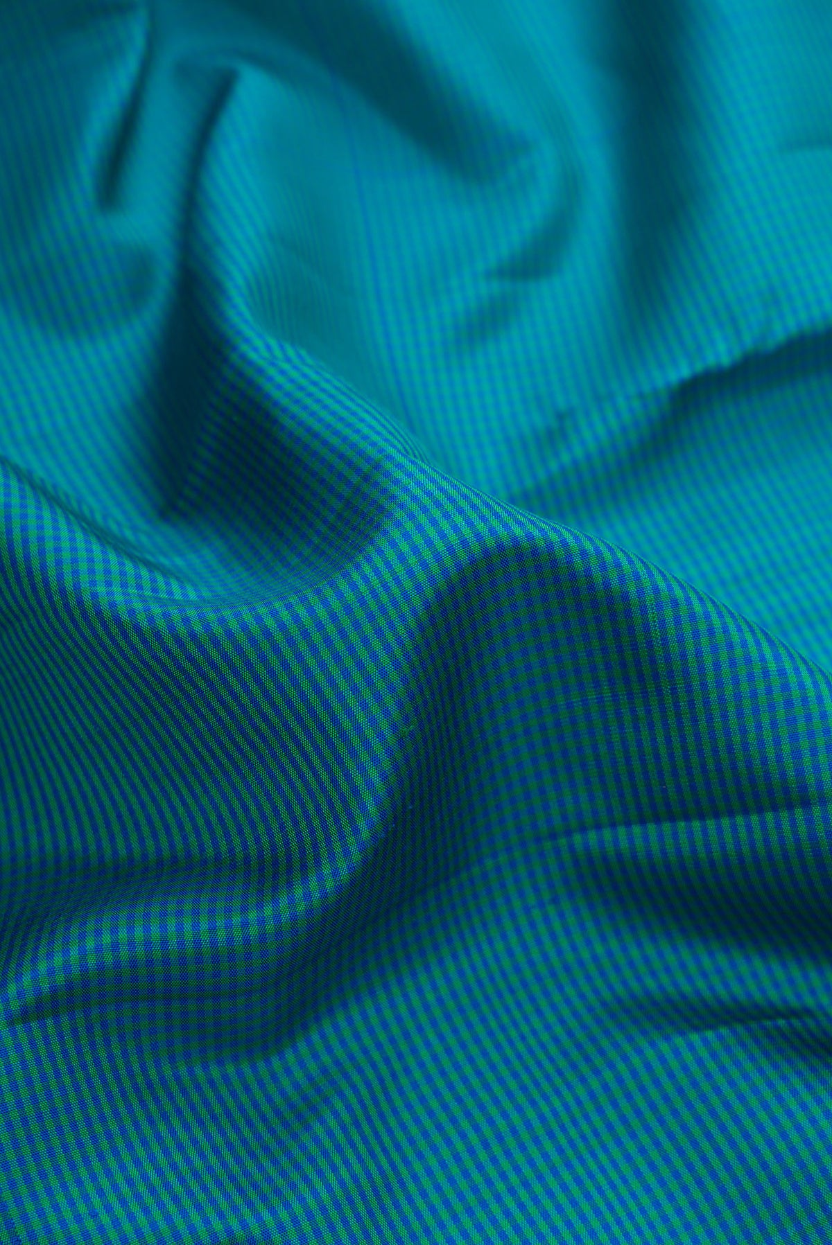 Close up of Pure Silk Peacock Blue Dual Tone Kanjivaram Saree with Checked design on the body and Zari Border.  displaying folds