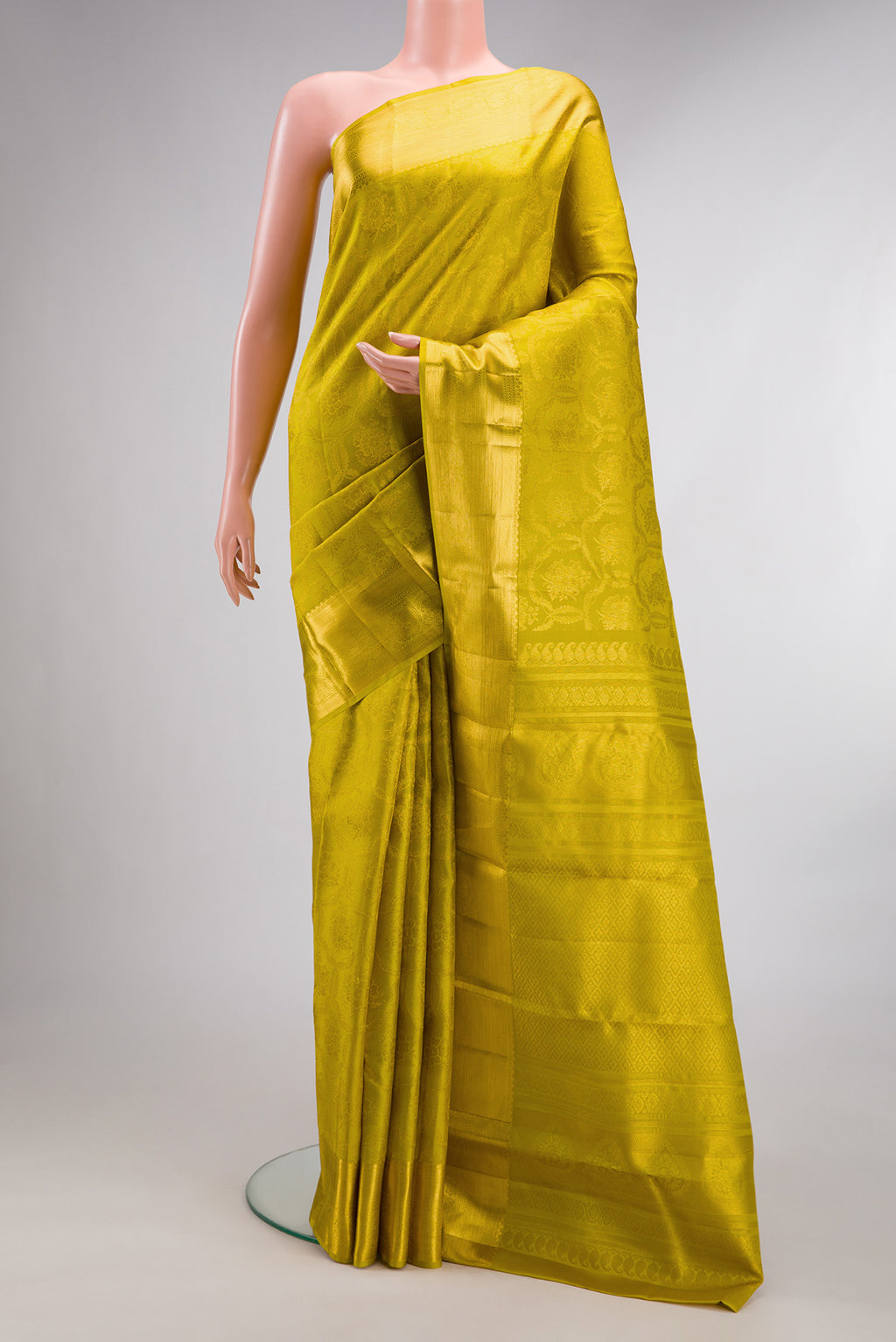 Pure Silk Green Dual Tone Kanjivaram Saree with Zari Brocade on the body and Zari Border.  displayed on a mannequin
