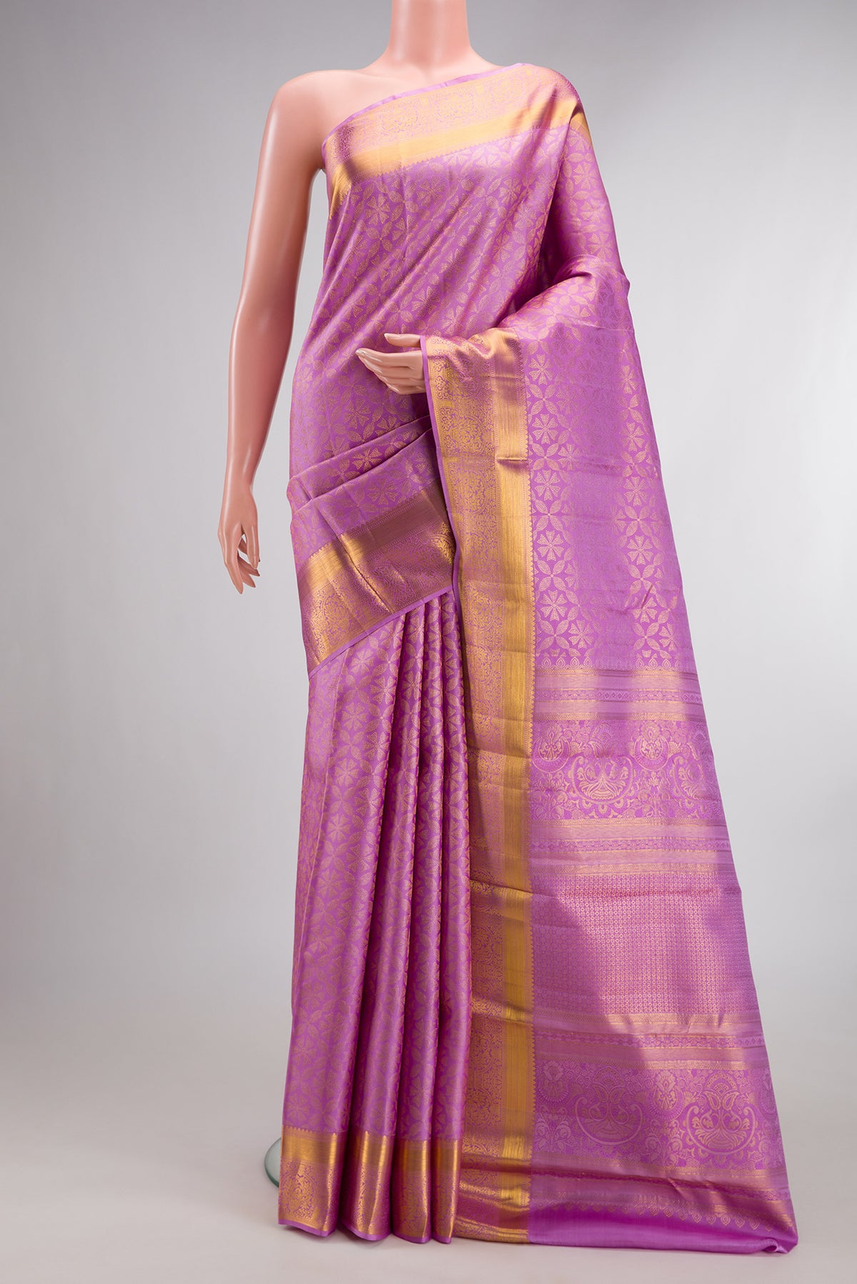 Pure Silk Lavender Kanjivaram Saree with Zari Brocade on the body and Zari Border.  displayed on a mannequin