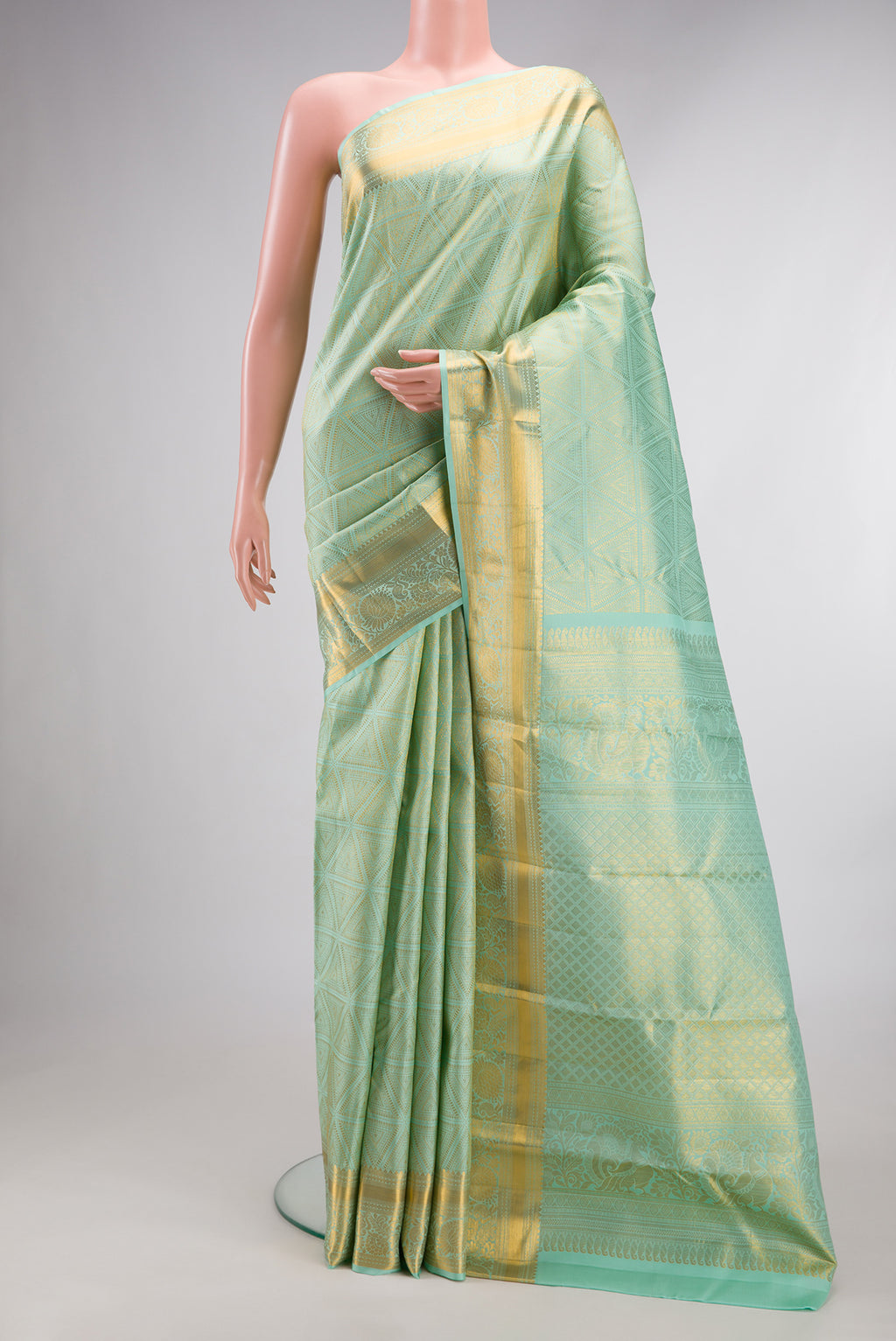 Pure Silk Mint Green Kanjivaram Saree with Zari Brocade on the body and Zari Border.  displayed on a mannequin