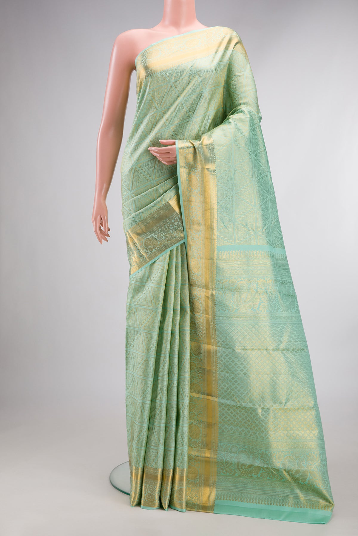 Pure Silk Mint Green Kanjivaram Saree with Zari Brocade on the body and Zari Border.  displayed on a mannequin