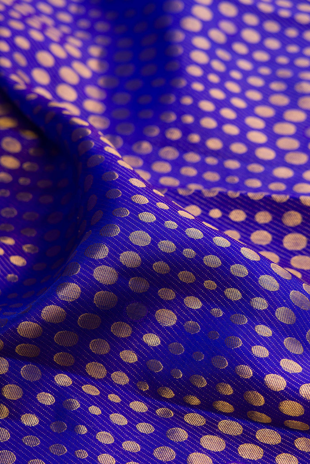 Close up of Pure Silk Royal Blue Dual Tone Kanjivaram Saree with Zari Brocade on the body and Zari Border.  displaying folds