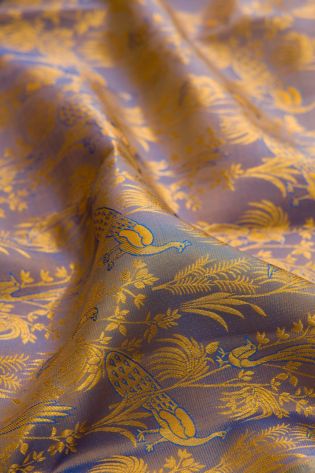 Close up of Pure Silk Light Blue Dual Tone Kanchipuram Saree with Zari Brocade on the body and Zari Border.  displaying folds