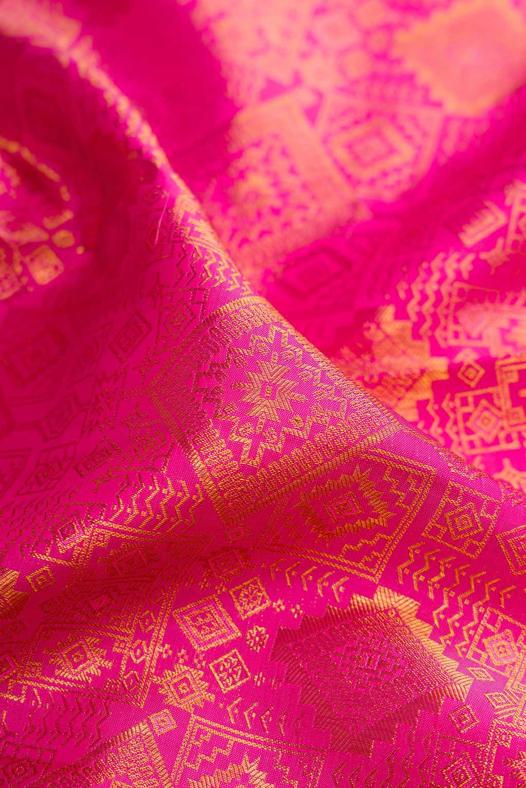 Close up of Pure Silk Pink Kanchipuram Saree with Zari Brocade on the body and Zari Border.  displaying folds